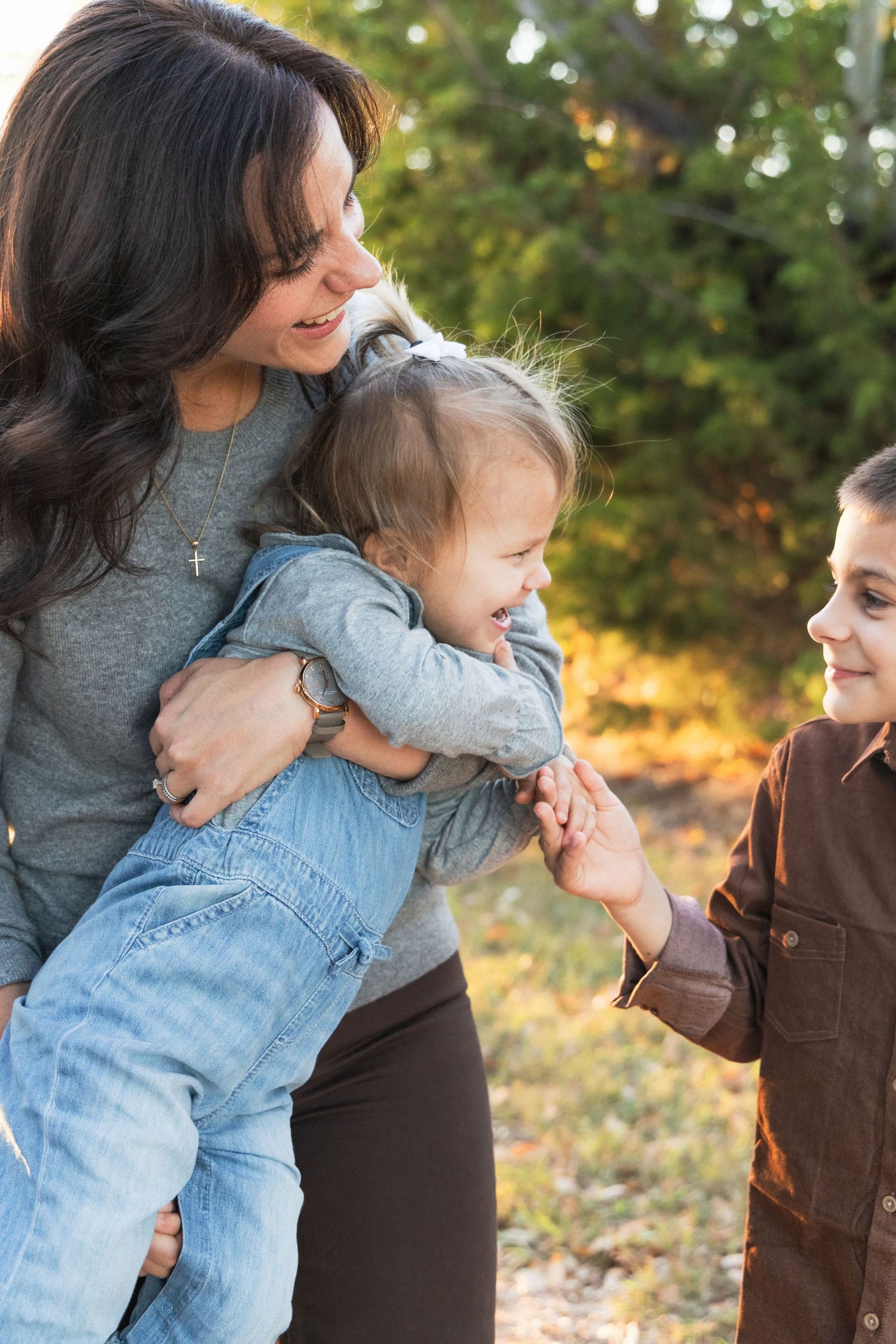 Mom holds toddler in overalls | Candid family photography | Austin Family photographer
