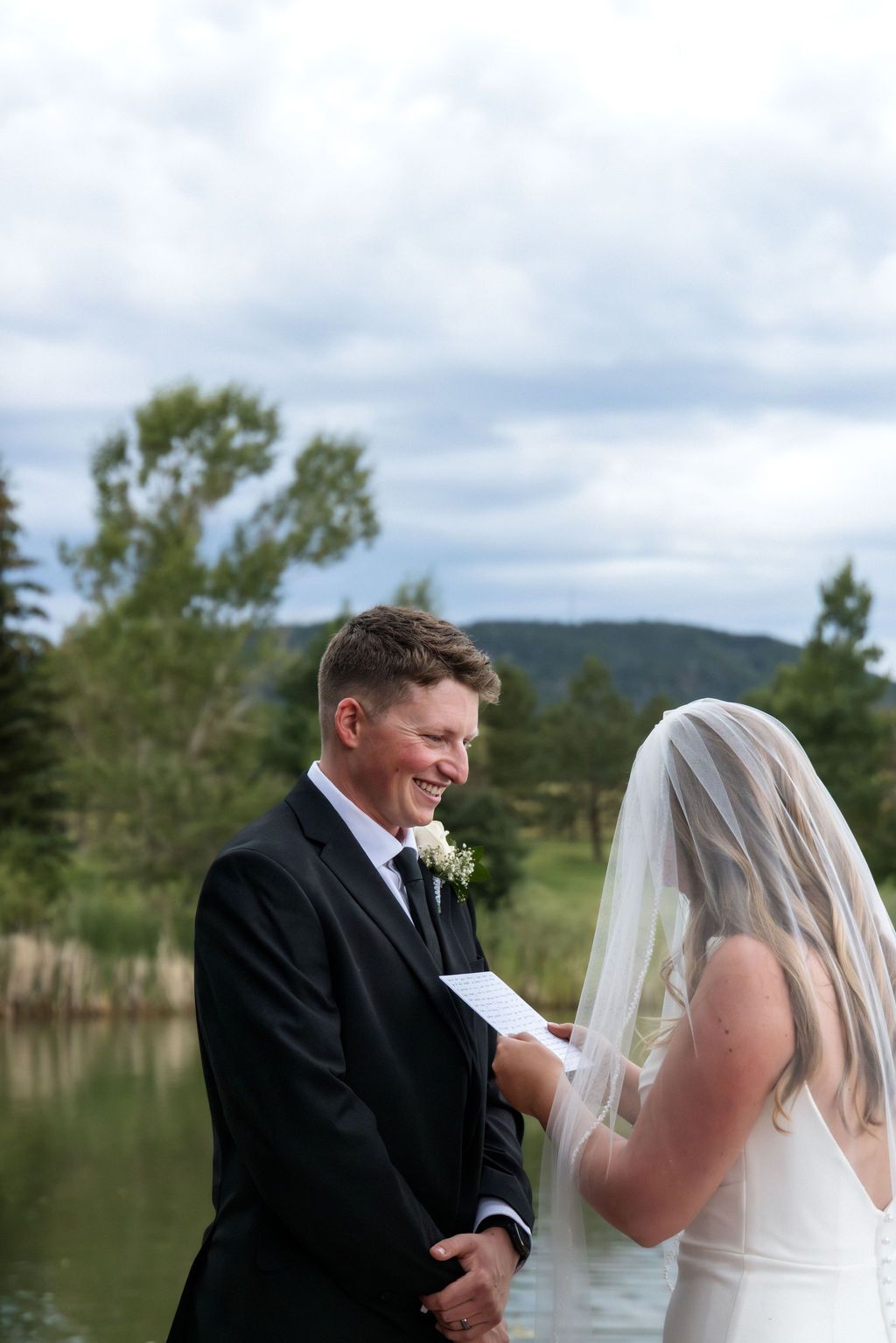 Bride and groom read vows lakeside | Palmer Lake, Colorado | Outdoor wedding at Spruce Mountain Guest Ranch