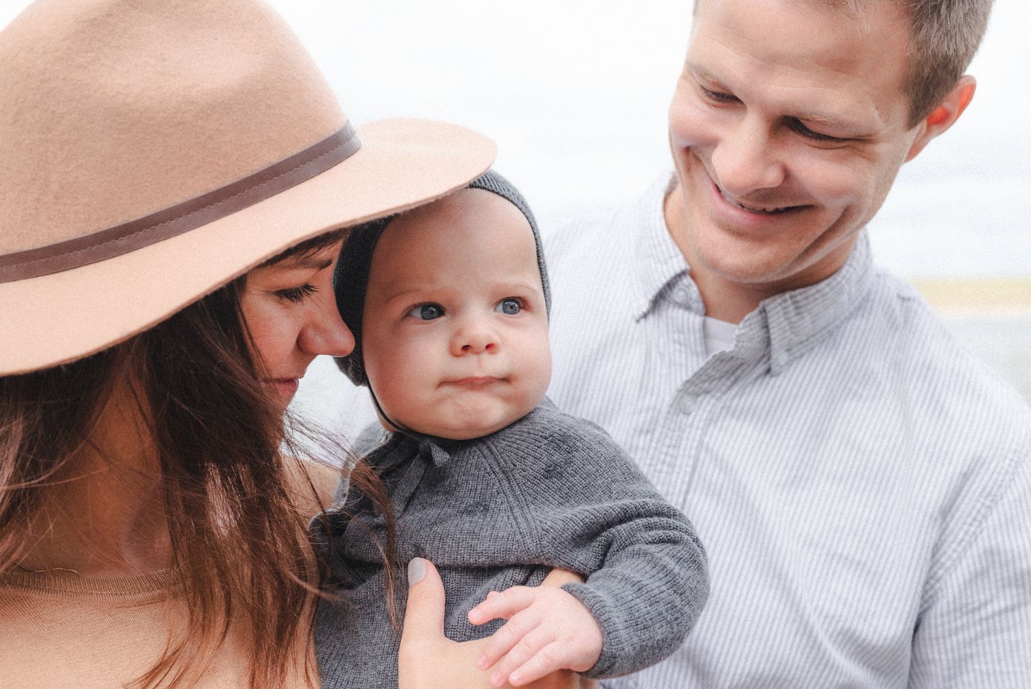 Mom and dad hold infant during during a ranch family photo session
