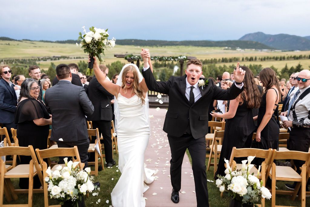 Bride and groom celebrating down the aisle | Palmer Lake, Colorado | Outdoor wedding at Spruce Mountain Guest Ranch