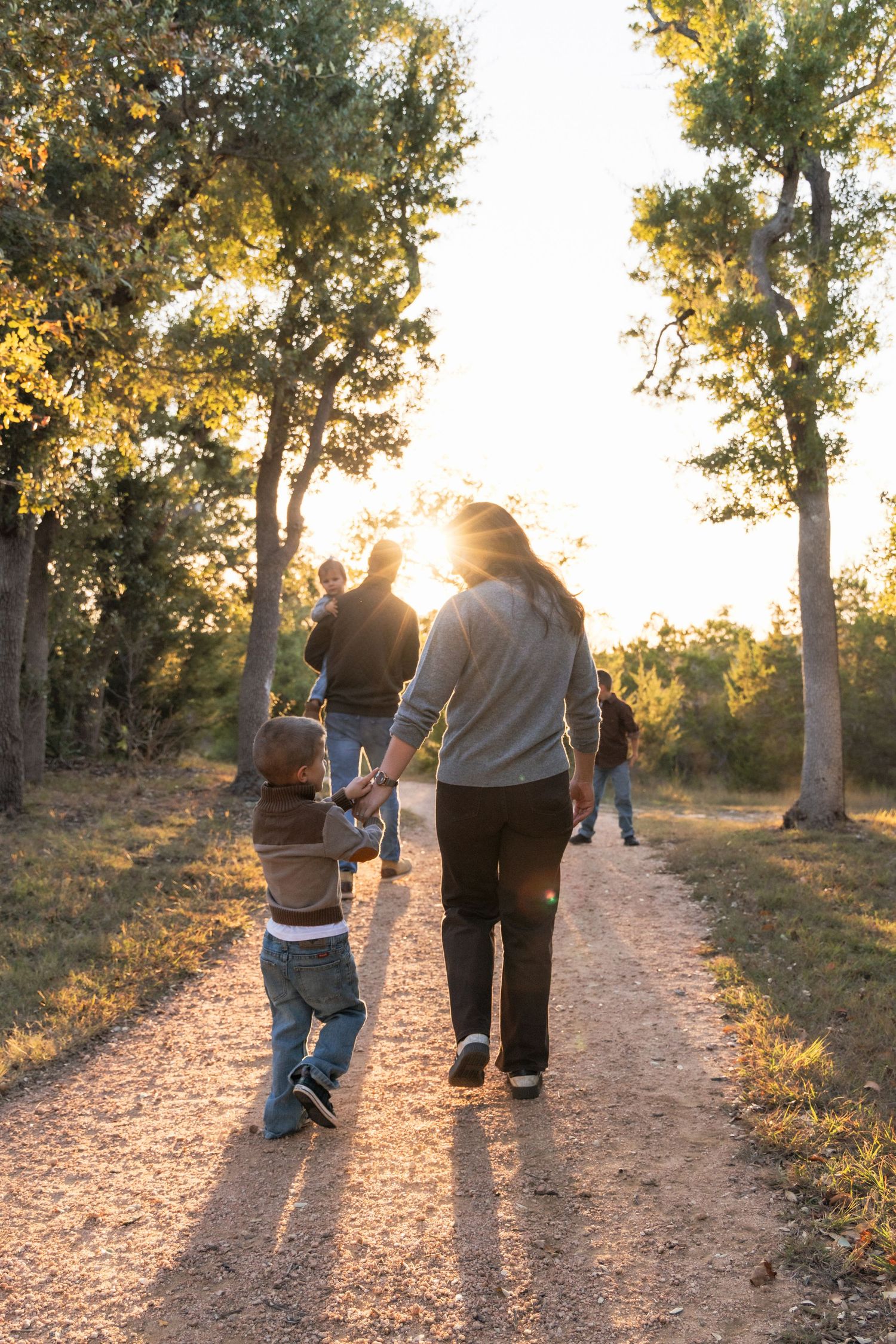 Family exploring trails during sunset family photography session | Texas Hill Country