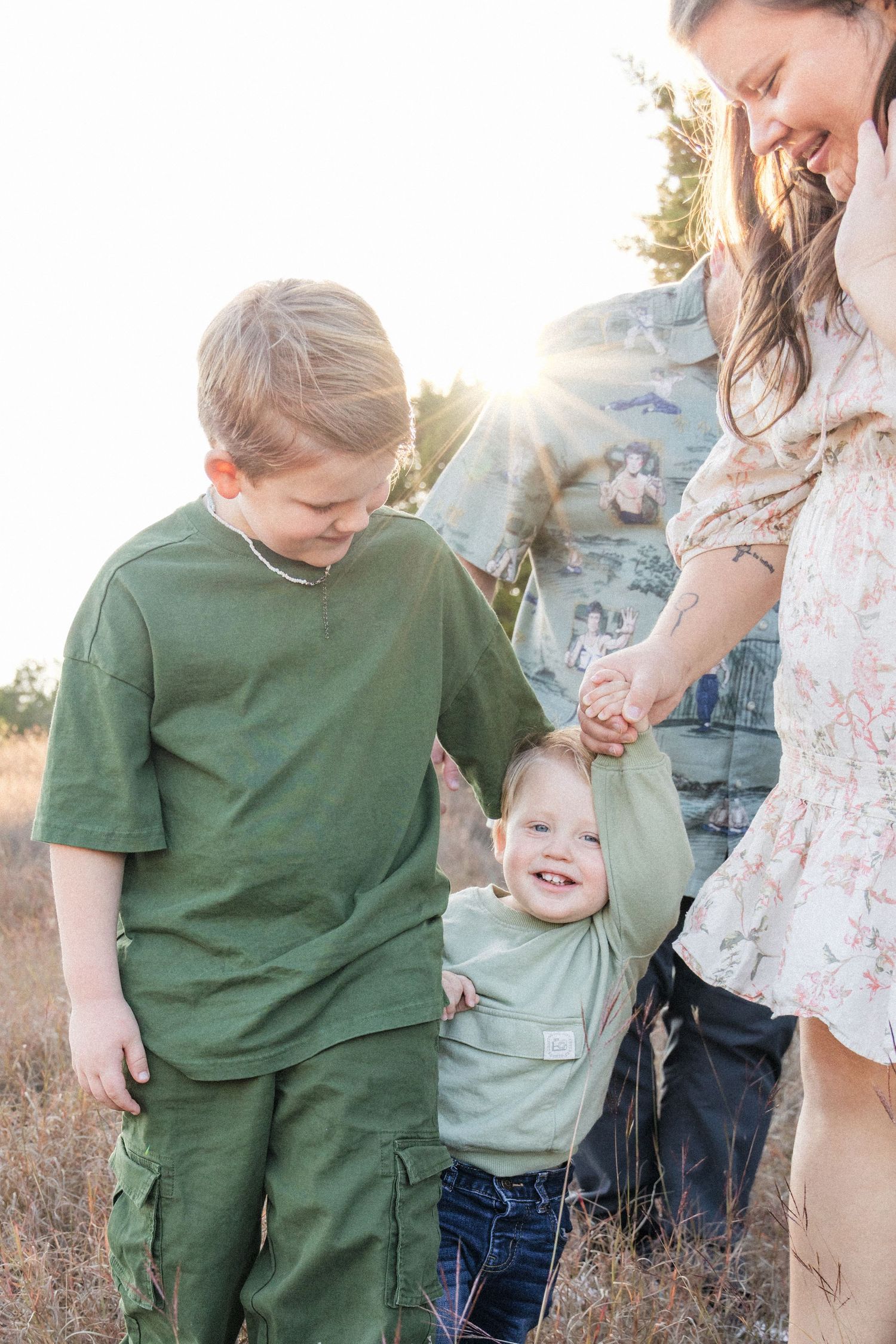 Young brothers play together during sunset family photo session