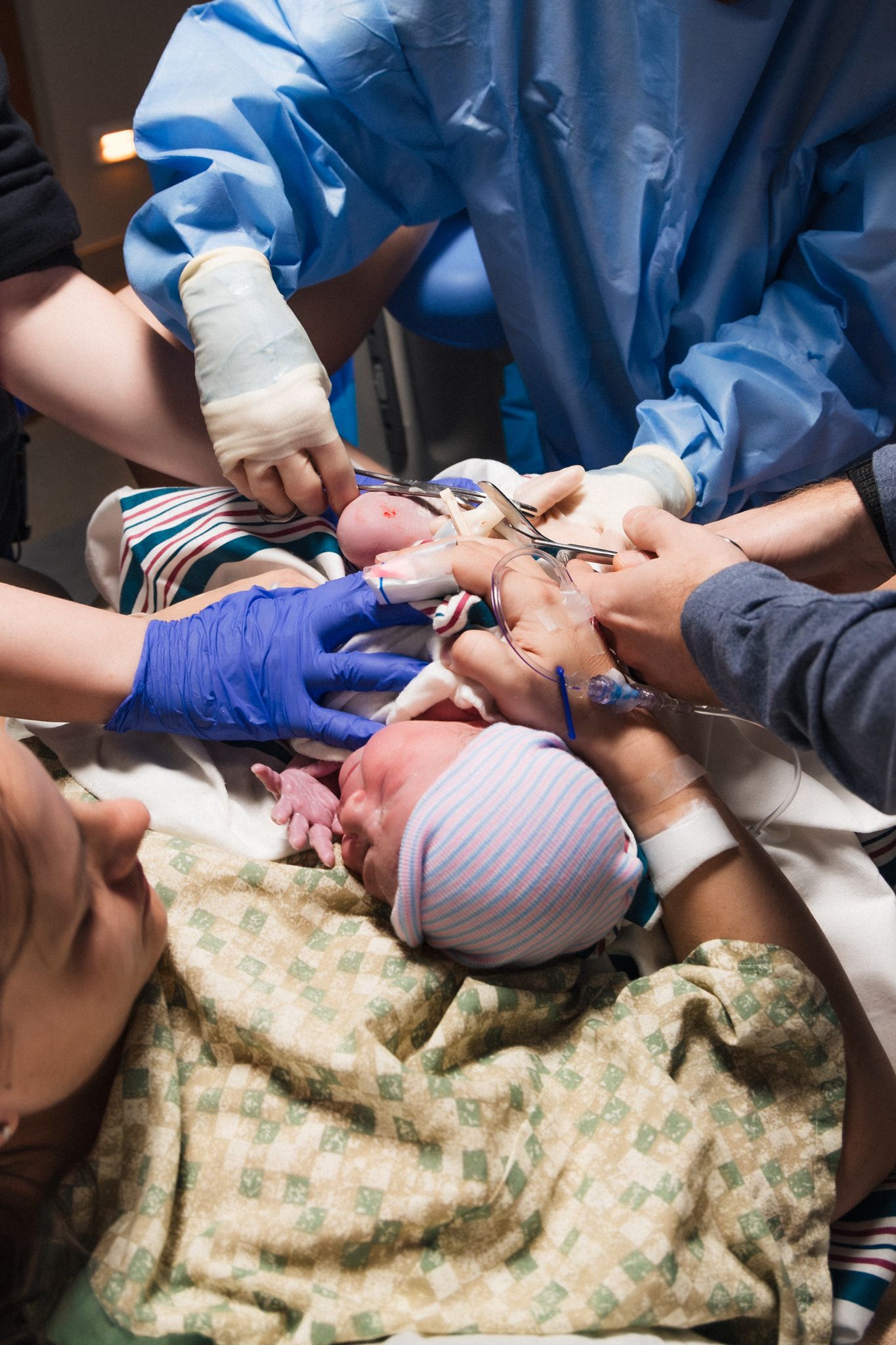 Doctor and nurses cutting cord during hospital birth | Birth Photography Austin Texas