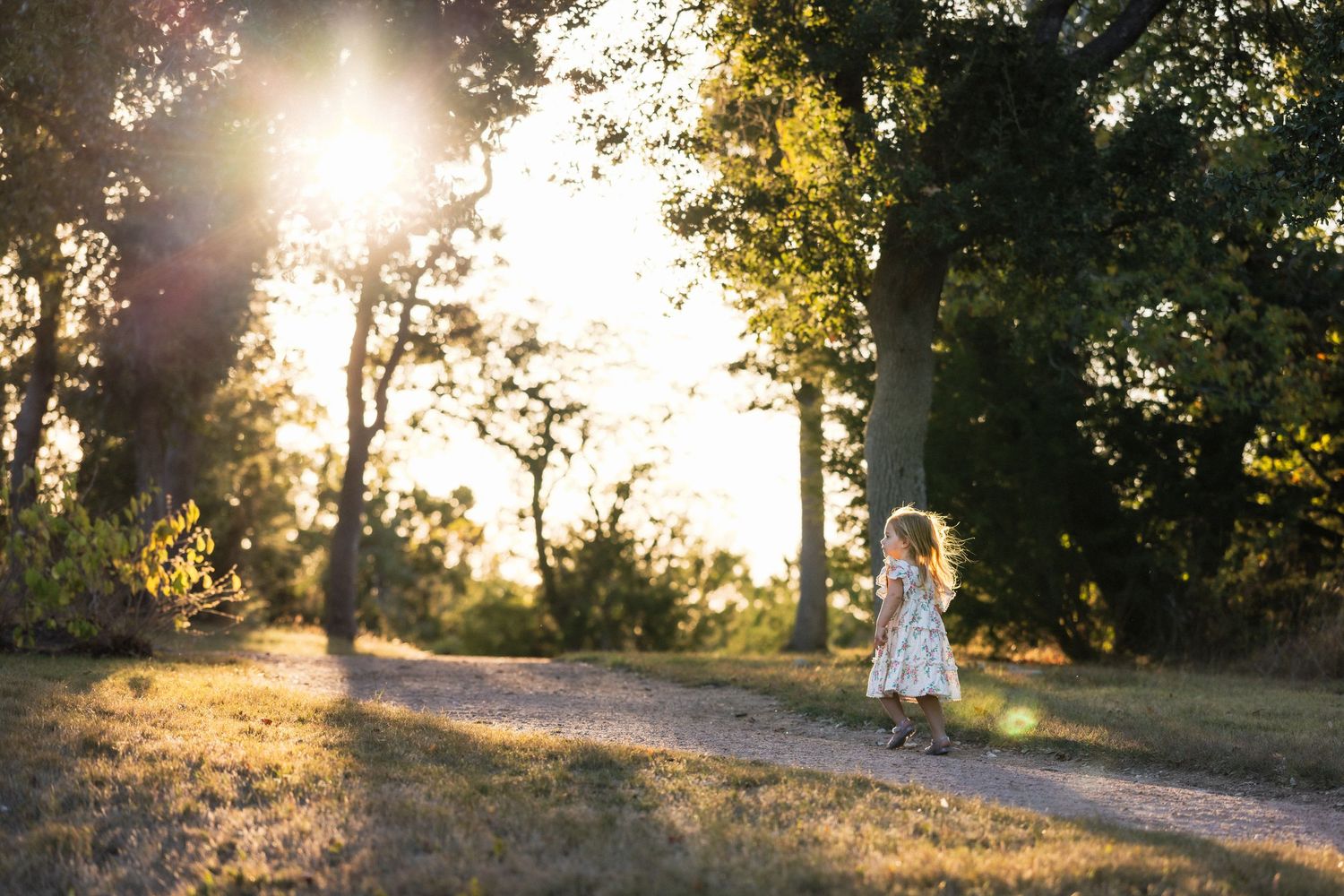 Little girl running and playing on trail during sunset family photography session | Texas Hill Country
