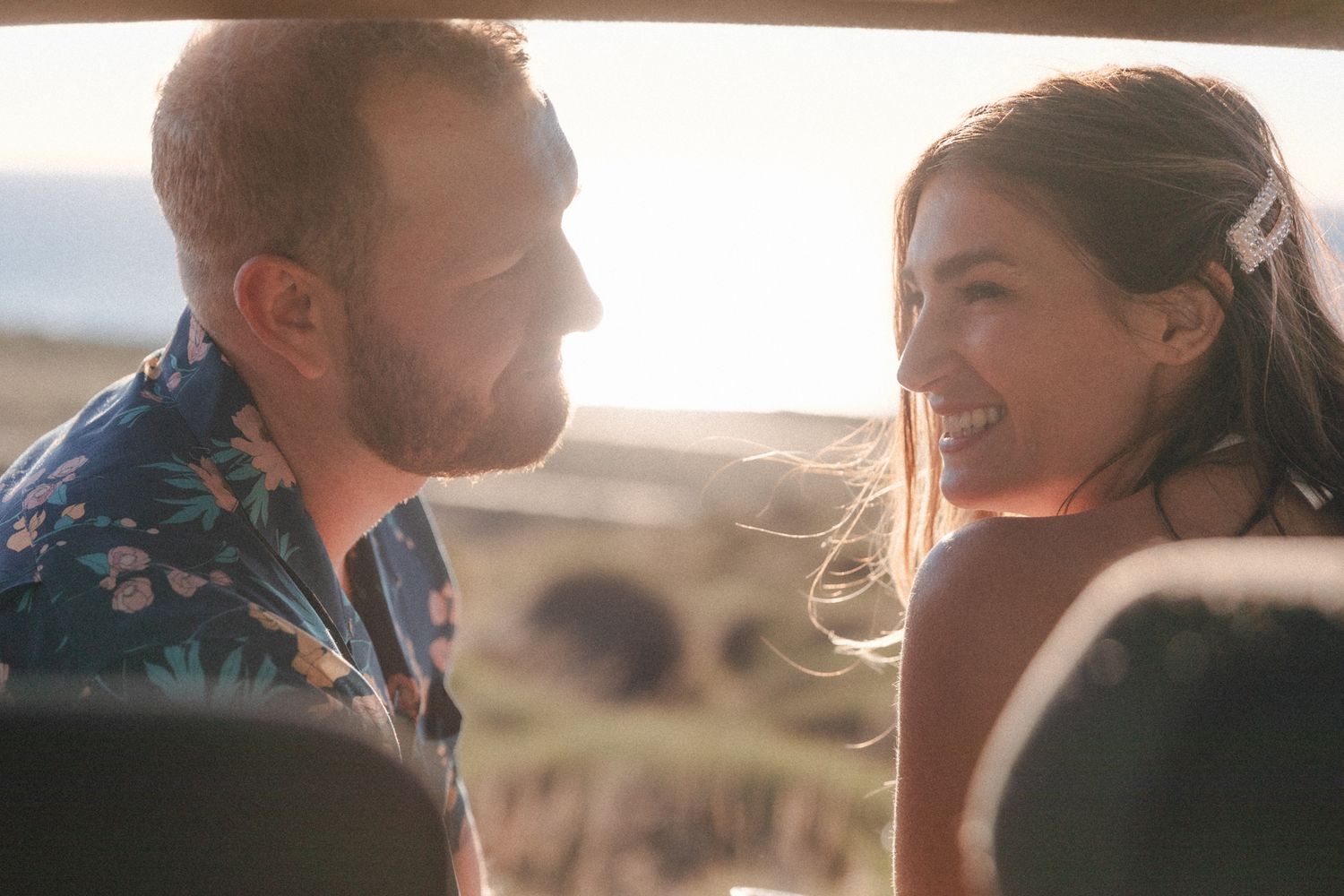 Couple shares sunset on the tailgate during casual beach elopement