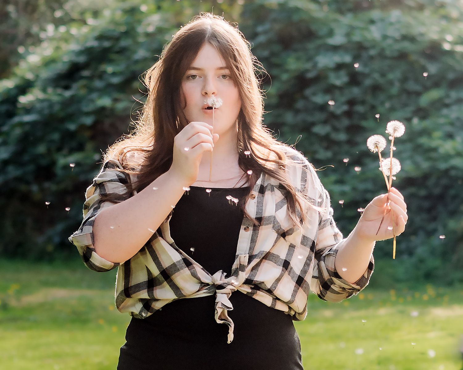 A series of playful poses against a natural outdoor backdrop with greenery.