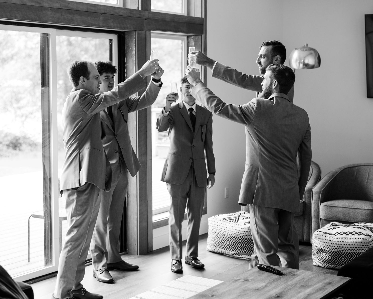 Black and white photos showing preparation moments by a window on a wedding day.
