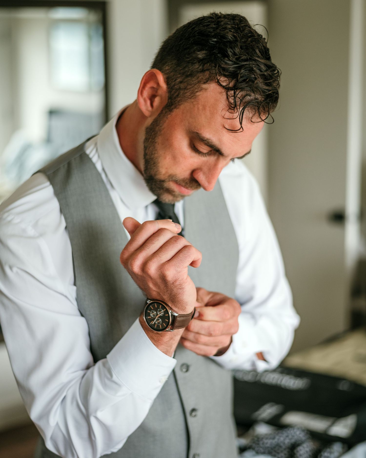 A person in a white dress shirt adjusts their tie while getting ready in a sequence of photos.