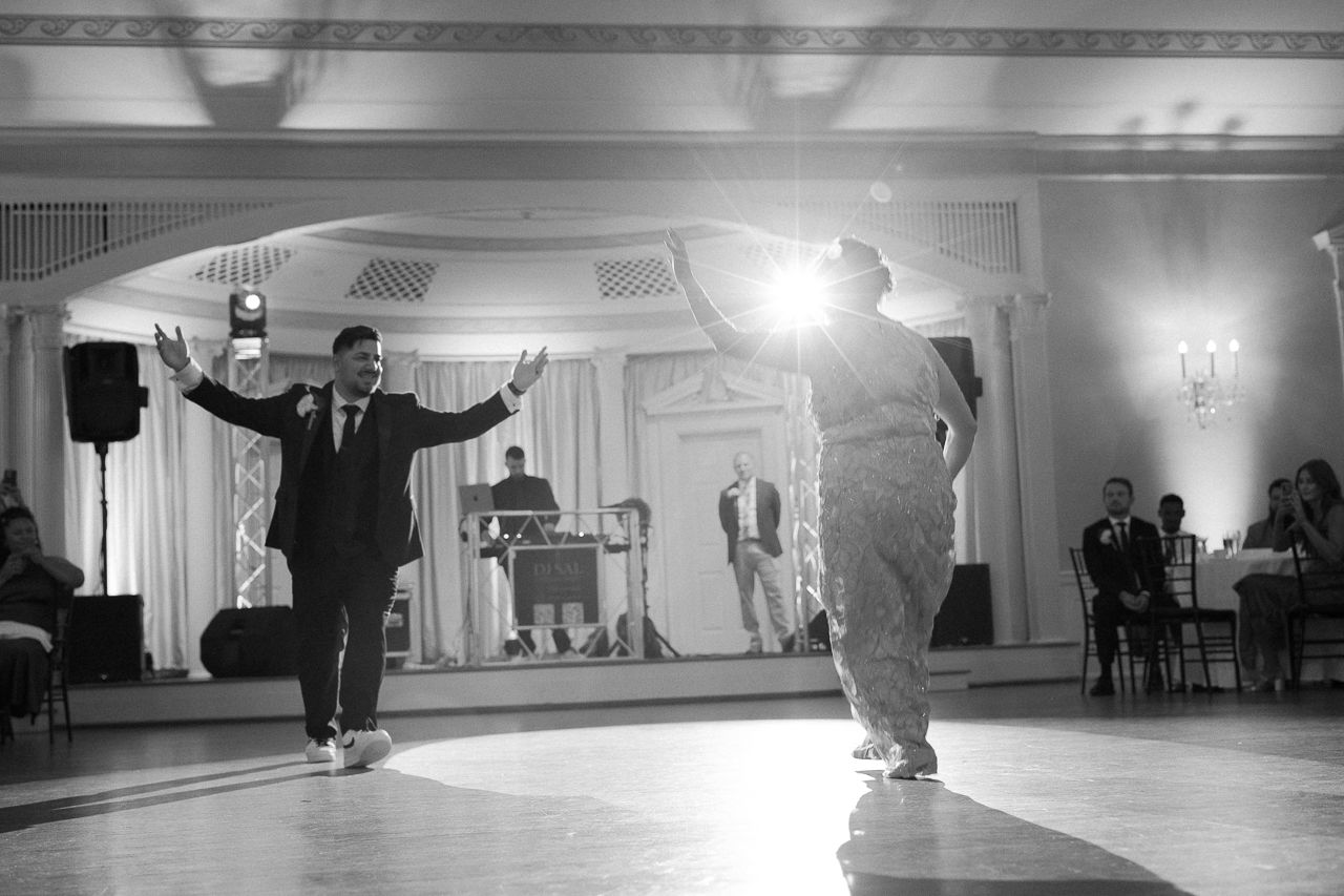 Empty ballroom with elegant decor and lighting setup for a wedding reception.