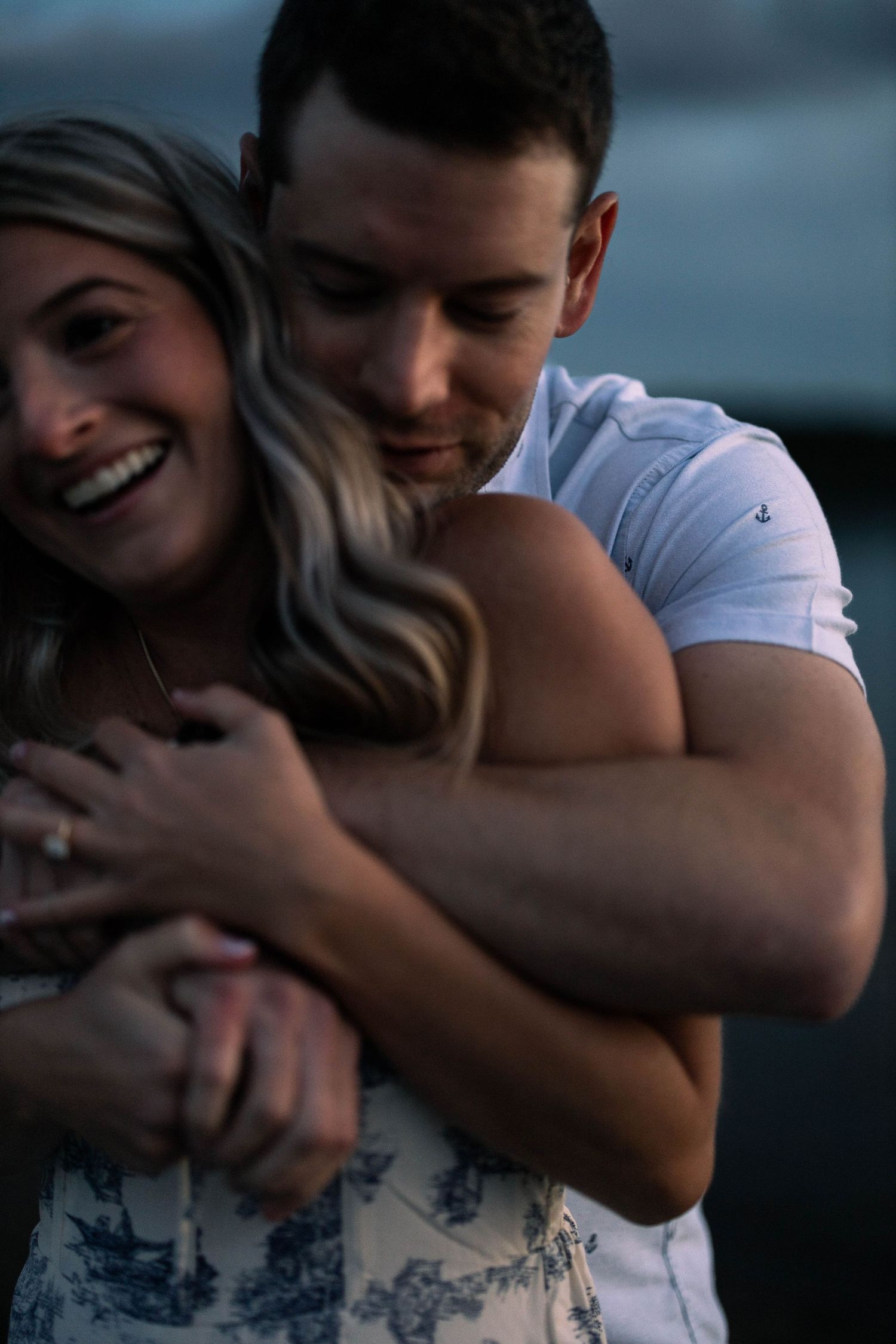 A romantic couple shares tender embraces in a series of intimate outdoor photos at dusk.