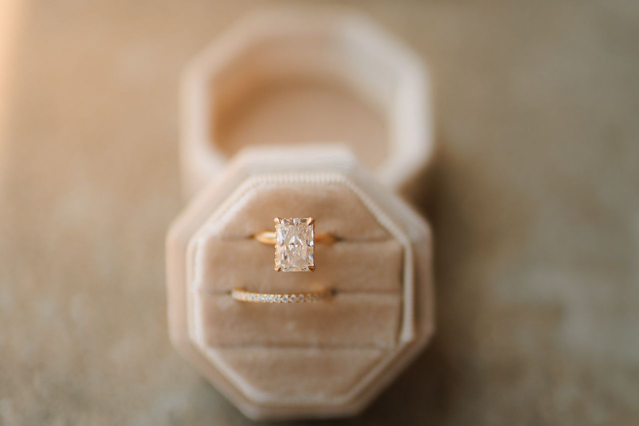 A close-up sequence showing an engagement ring in a box being opened and closed, revealing a sparkling diamond.