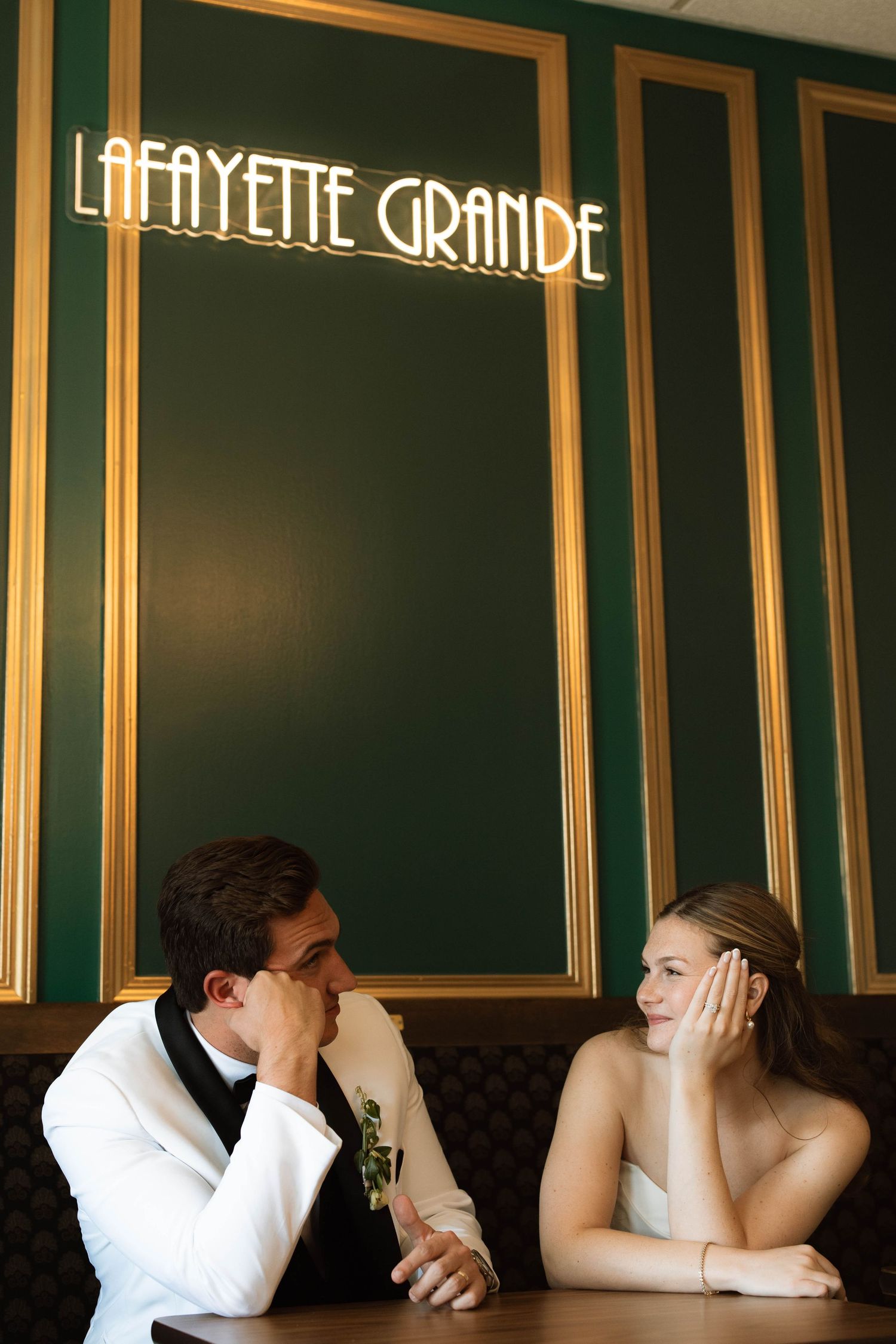 Bride and groom share a romantic moment at Lafayette Grande venue booth.