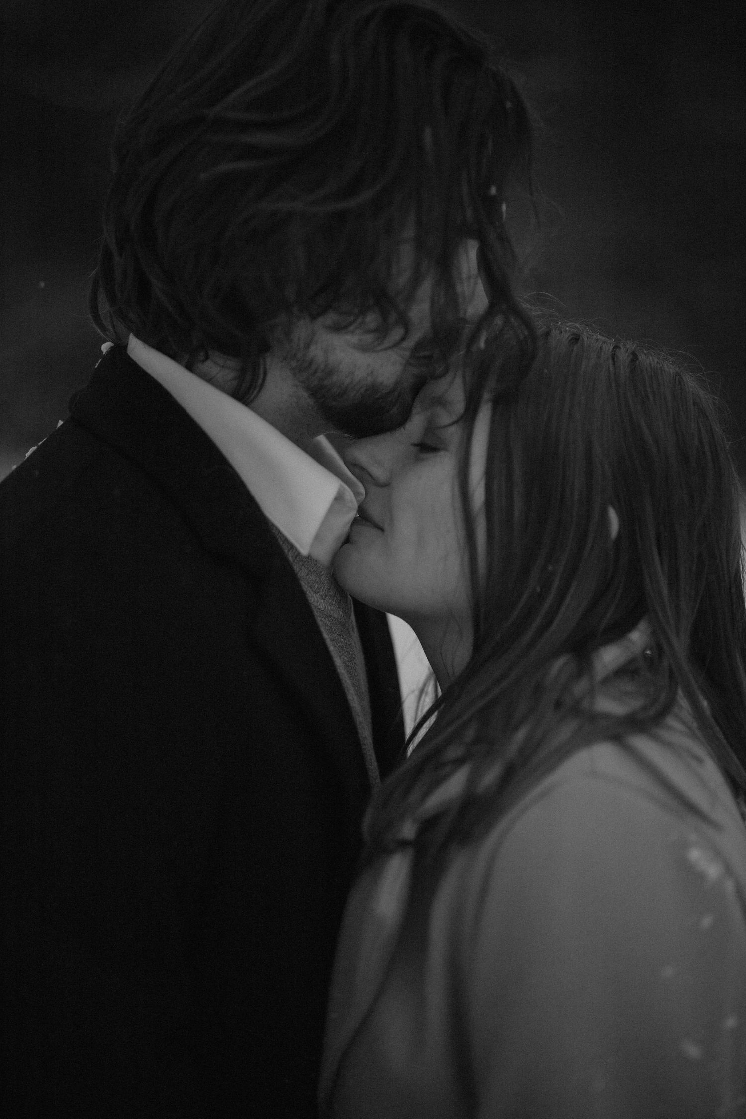 A romantic black and white photo sequence showing a couple embracing and sharing an intimate kiss.