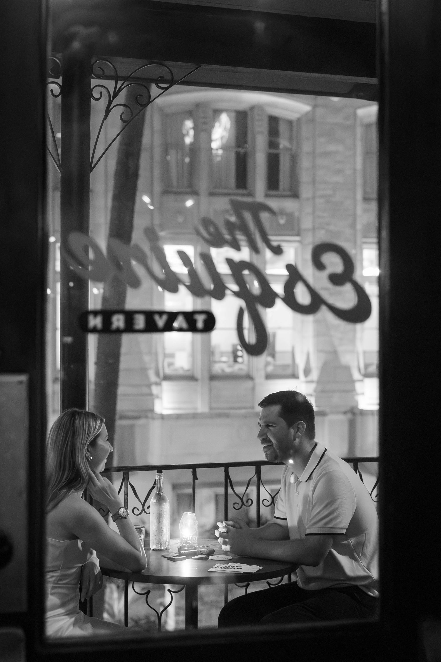Couple dining by candlelight inside The Engine Tavern restaurant, black and white photo.