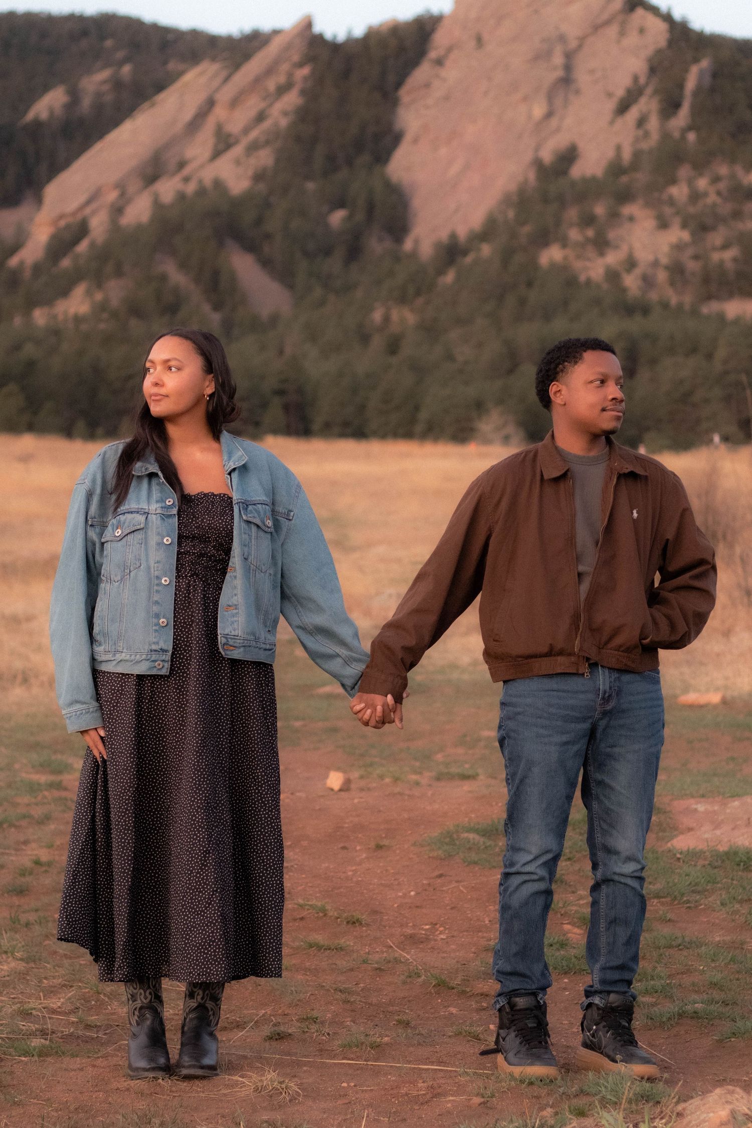 A couple holding hands and looking away from each other in Boulder, Colorado