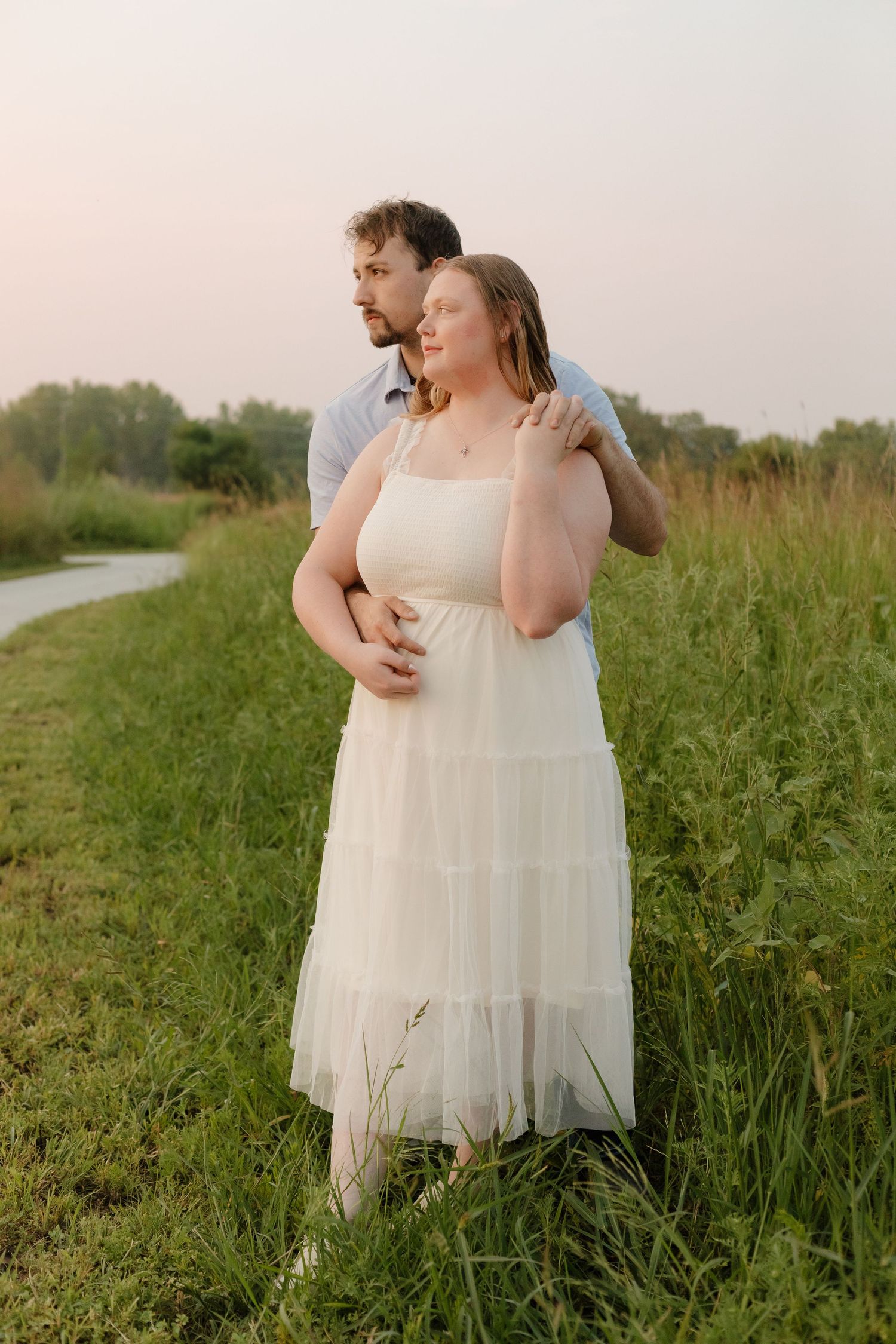 Romantic sunset photoshoot in a wildflower meadow wearing flowing white dresses.