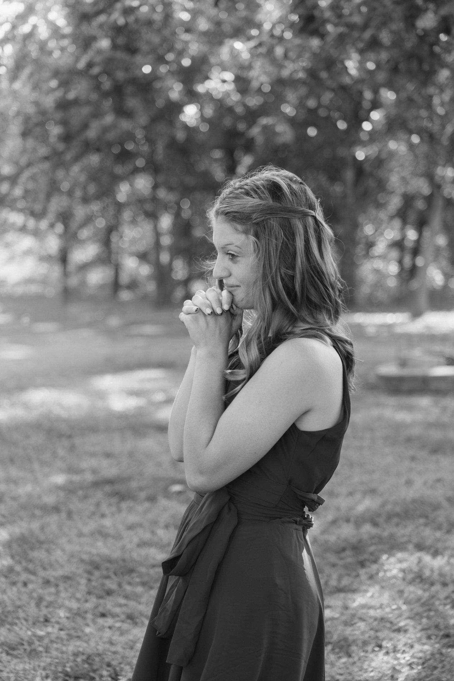 Black and white photograph of person taking pictures in natural outdoor setting.