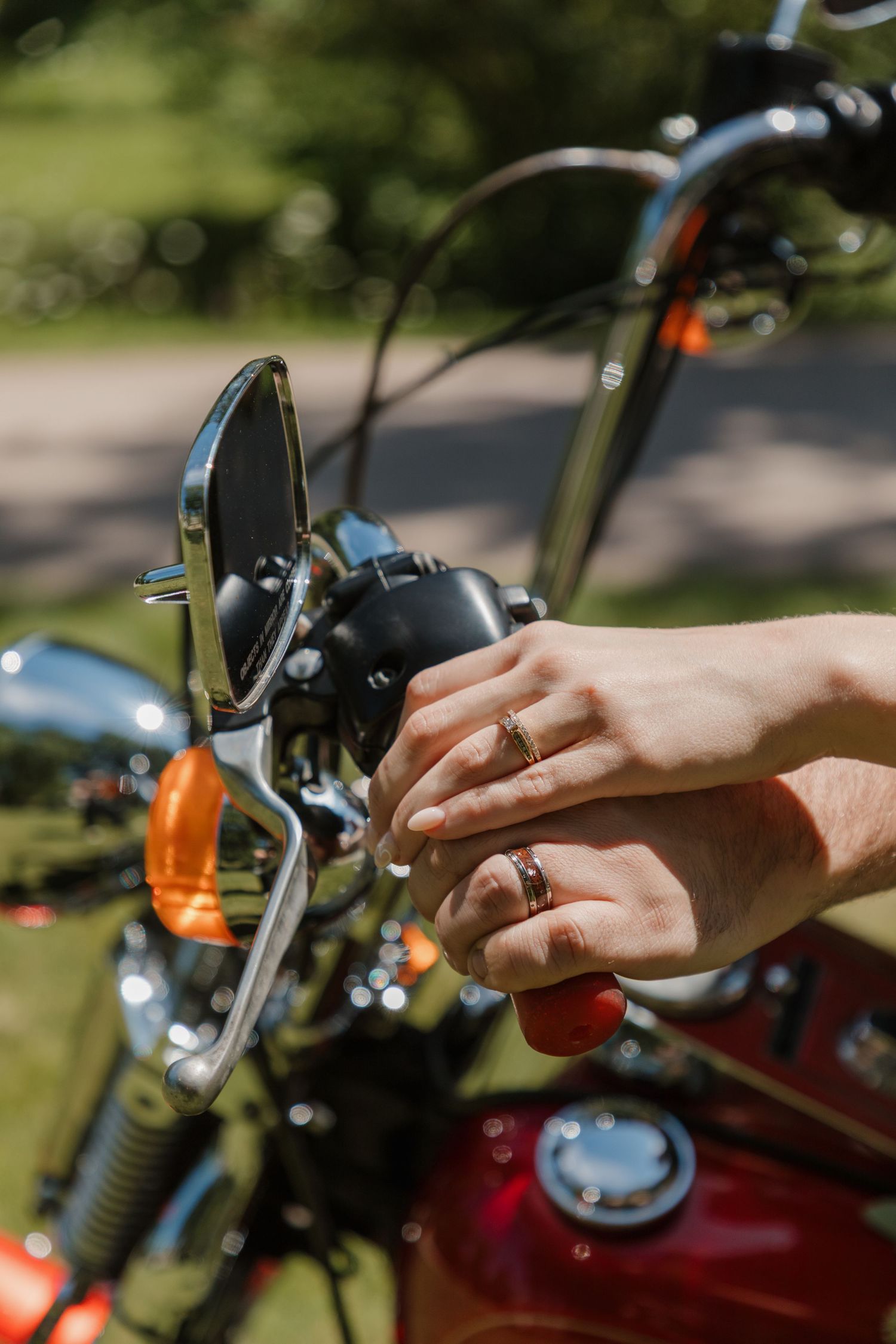 Close-up shots of hands adjusting motorcycle controls and handles.