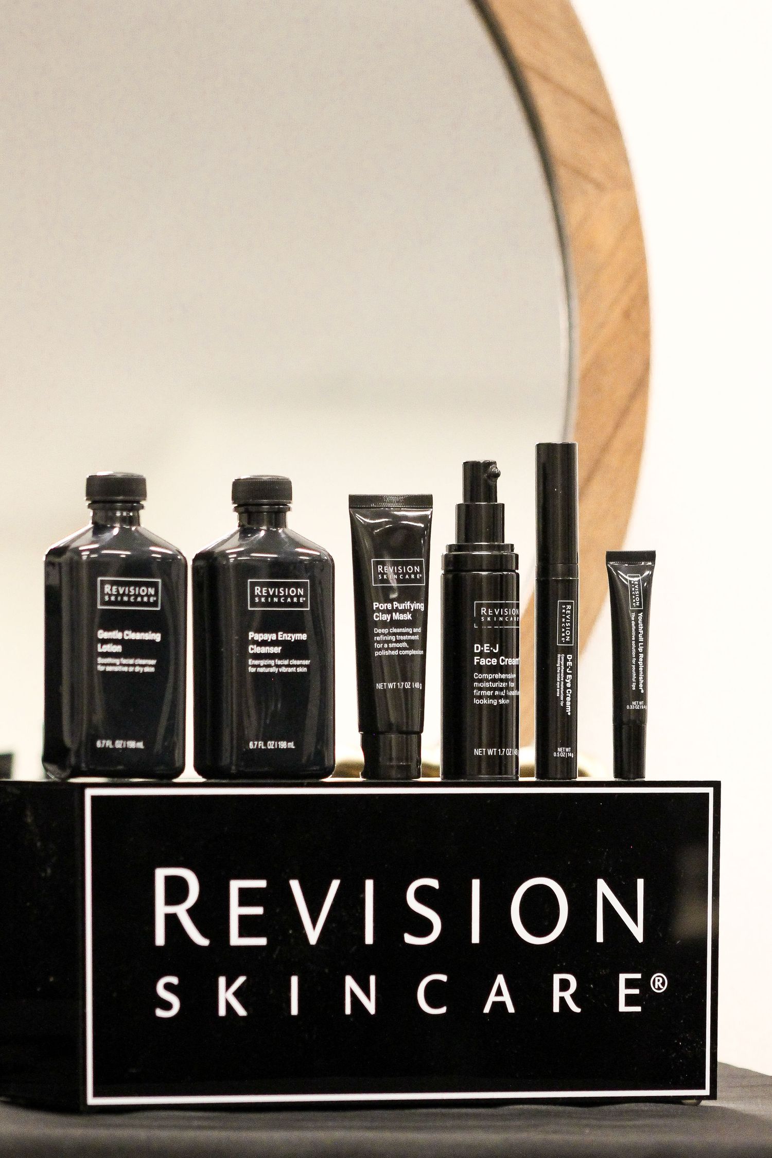 Display of Revision Skincare products arranged on a shelf with black and white branding.