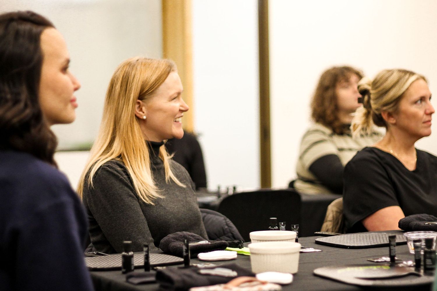 Group attending a professional training or seminar in a conference room setting.