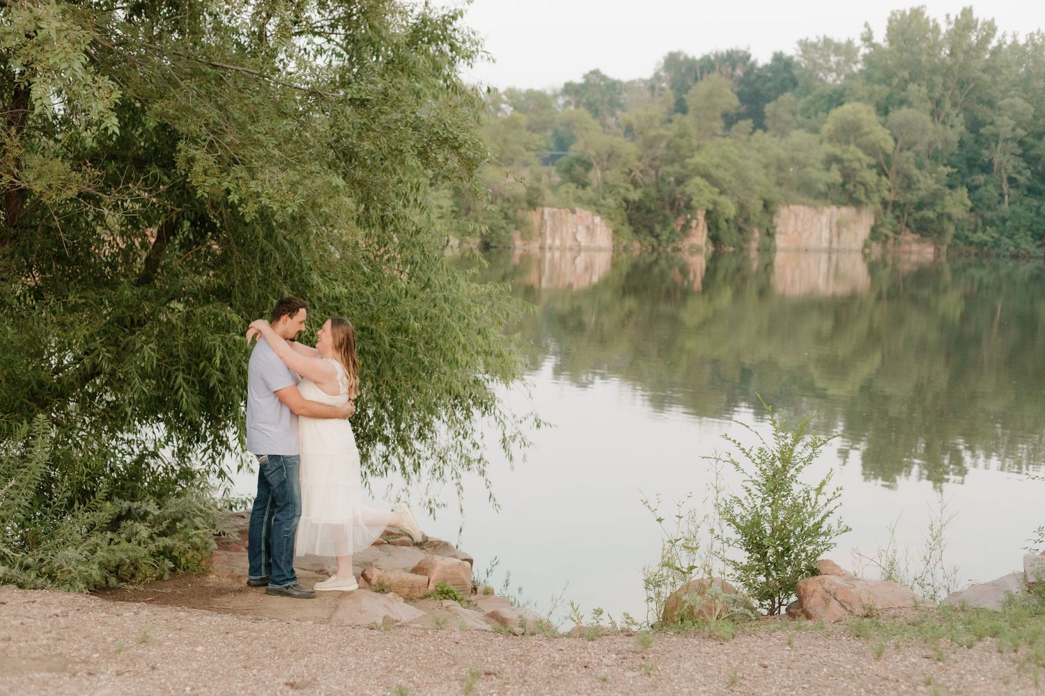 A scenic lakeside view with trees and water reflecting the peaceful surroundings.