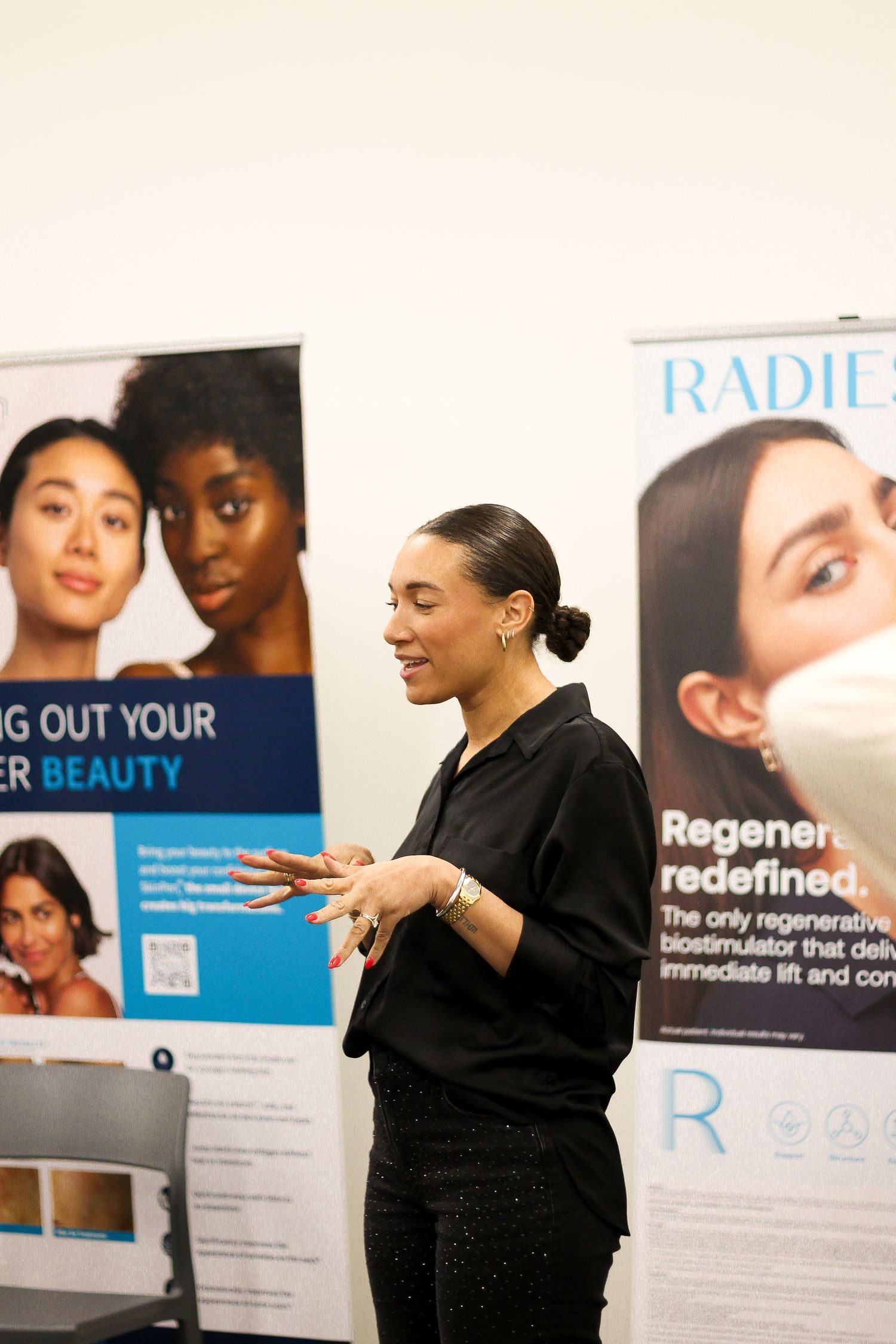 Professional presentation setup with beauty product banners and displays.