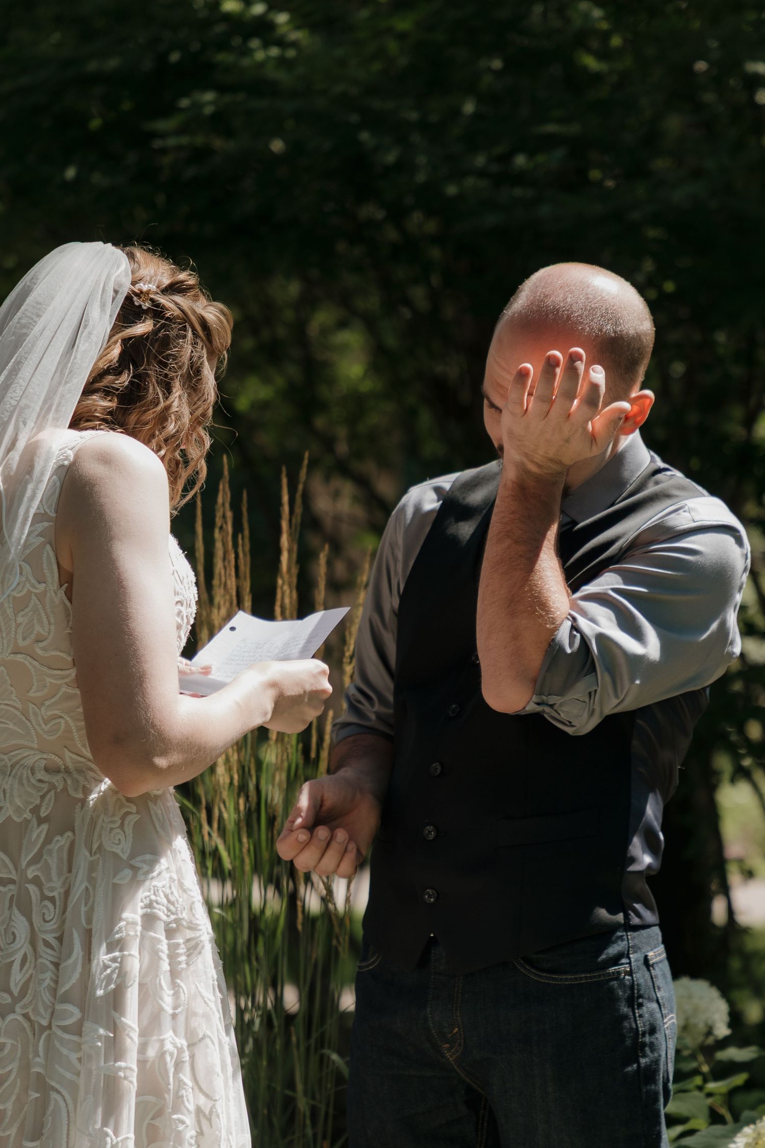 An emotional first look exchange in a garden setting at a wedding venue in Spearfish, South Dakota.
