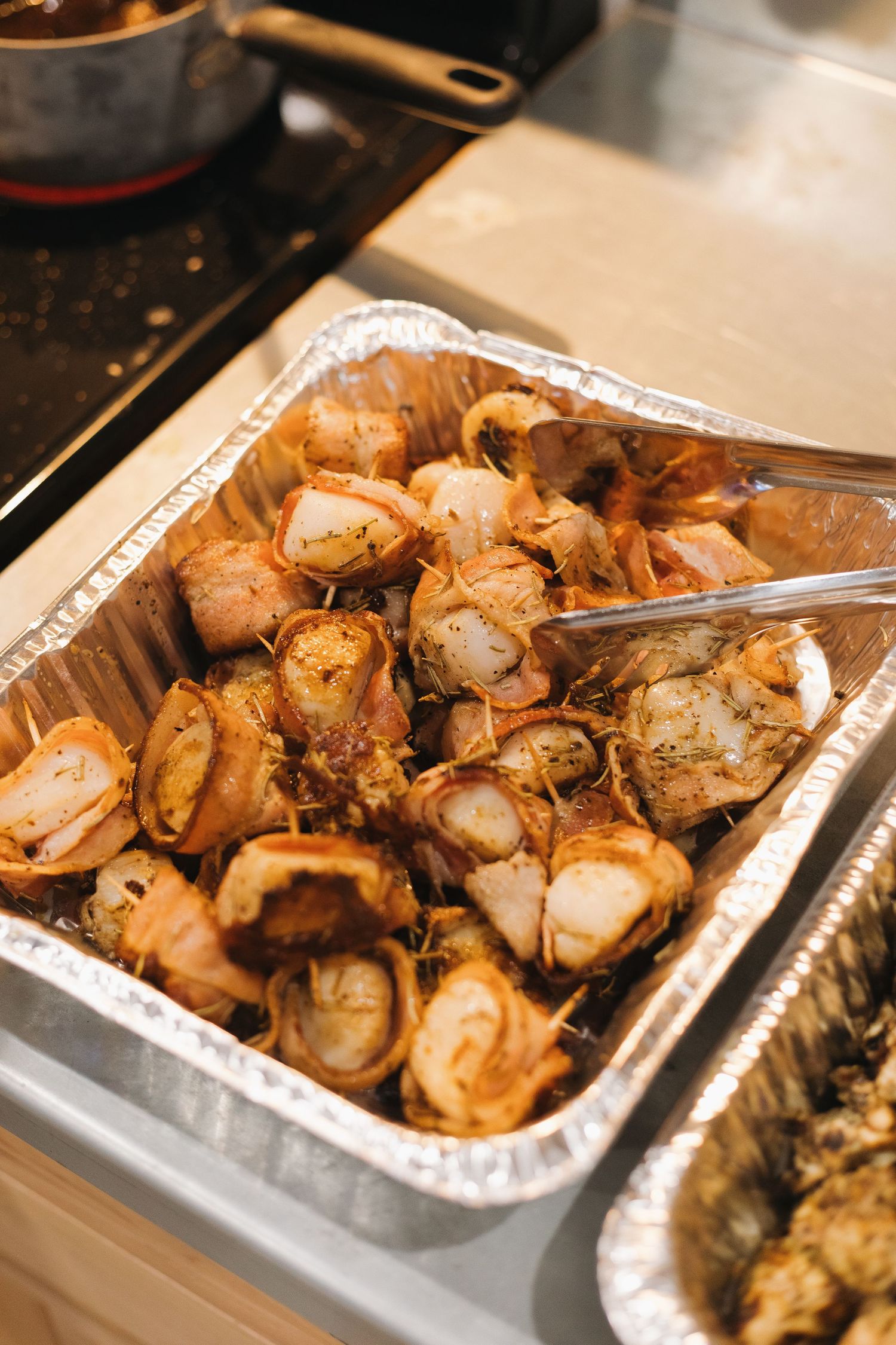 Bacon-wrapped grilled scallops arranged in a metal serving tray at a corporate dinner held at Wenzel's Pheasant Hills Lodge.