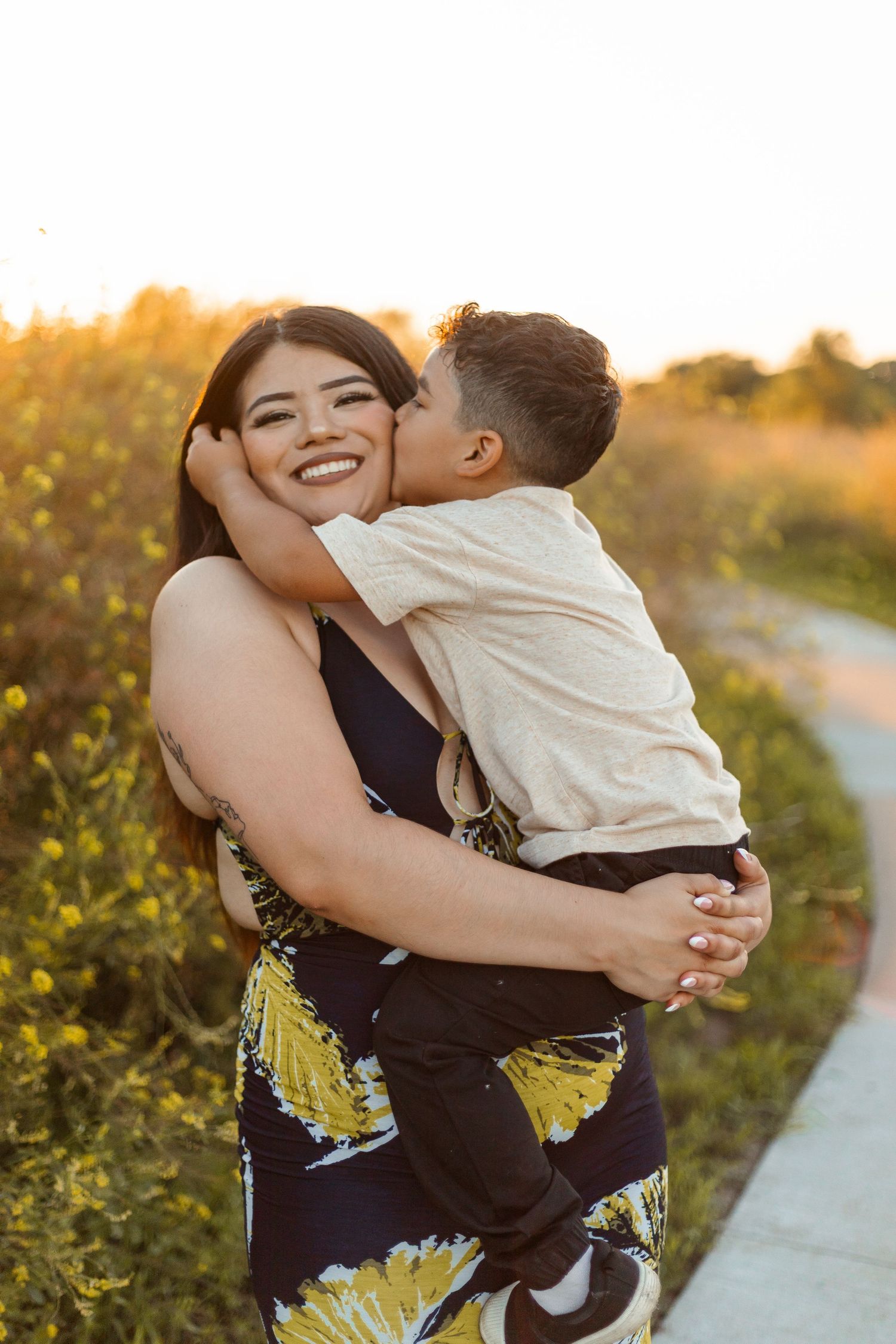 Candid outdoor family moments captured during golden hour on a nature path.