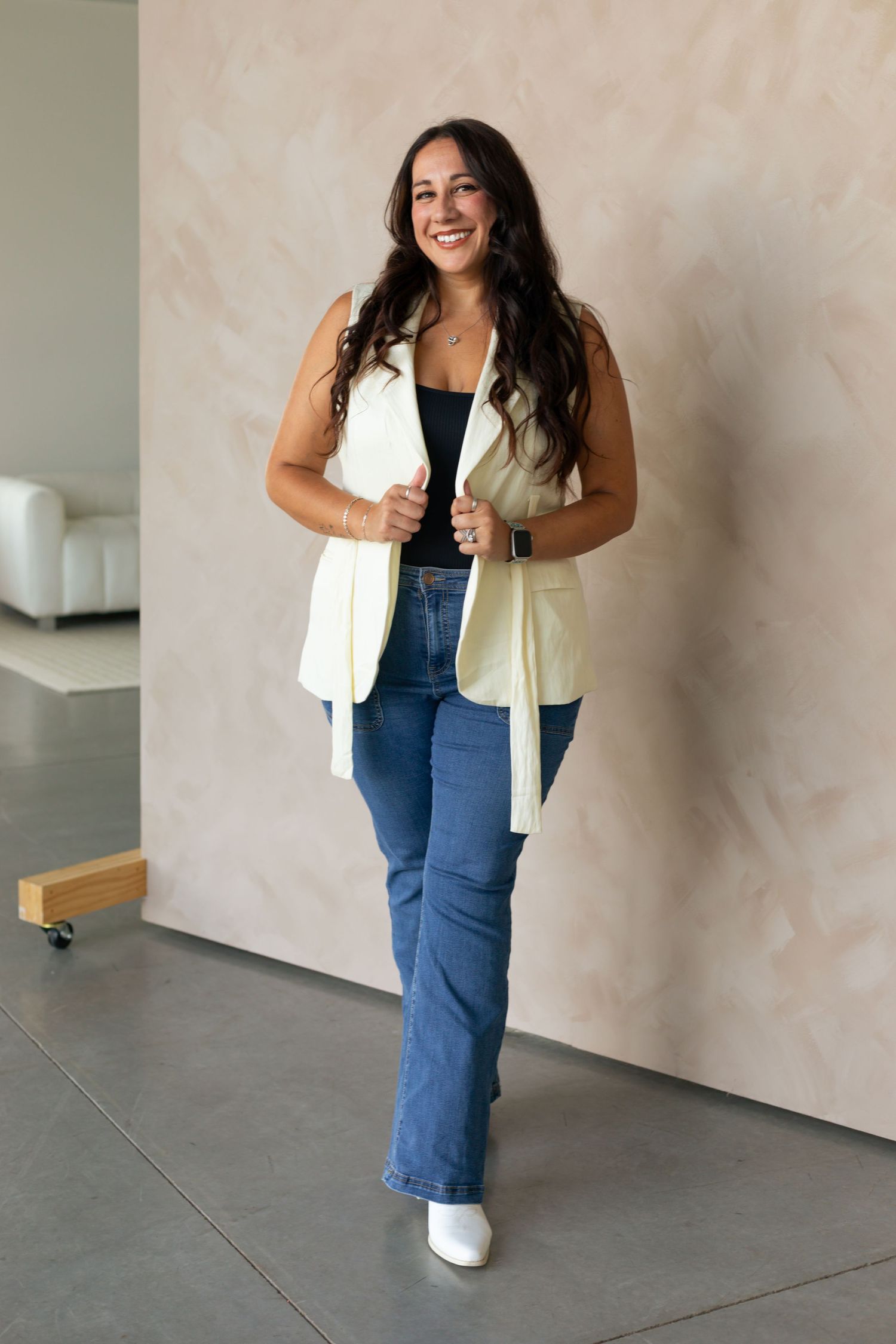 Fashion photo series showing casual denim and cream vest outfit on light background.