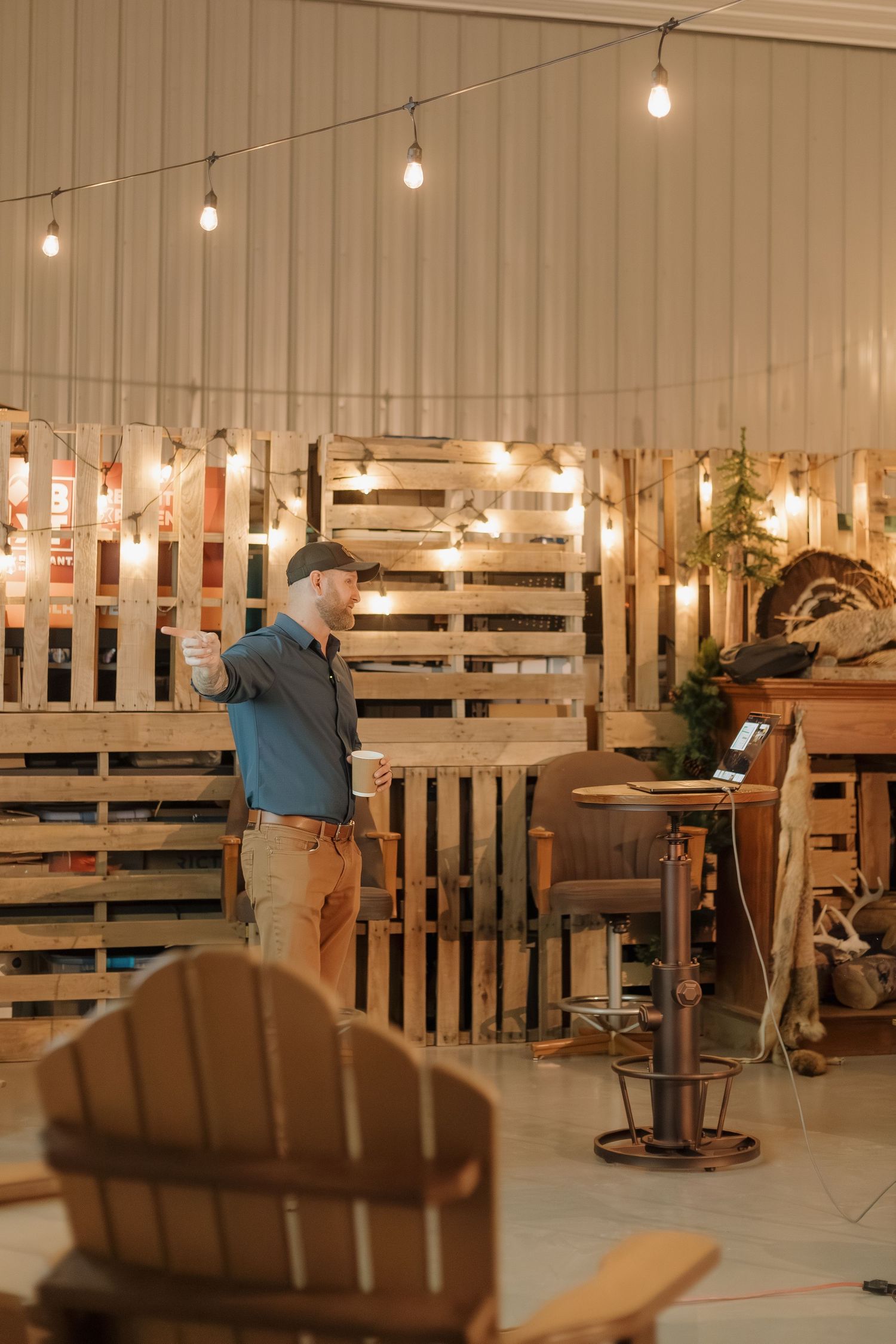 Rustic event space with wooden pallet walls and string lights creating an intimate atmosphere at Wenzel's Pheasant Hills Lodge.