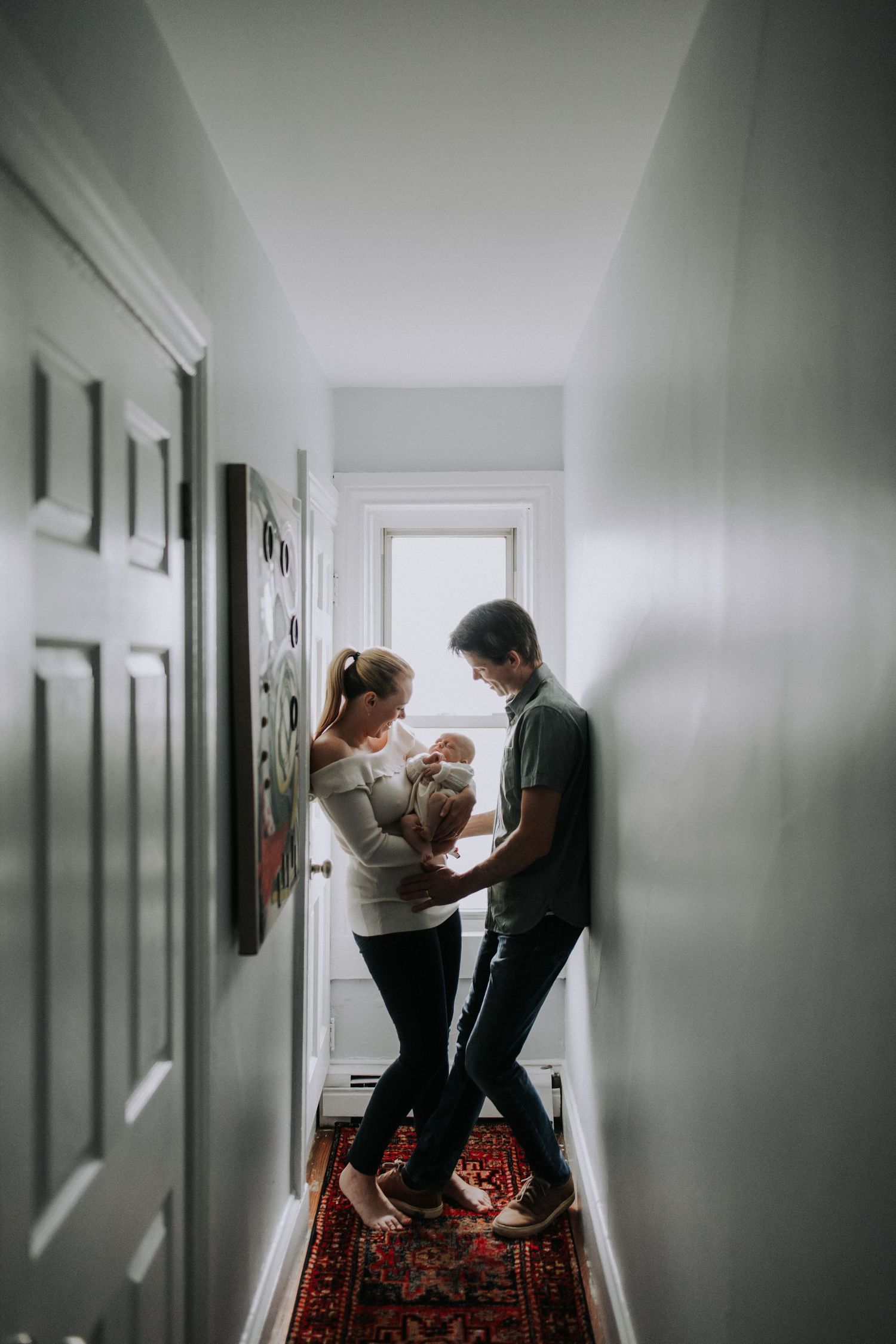 Dramatic hallway scene with moody lighting and patterned carpet.