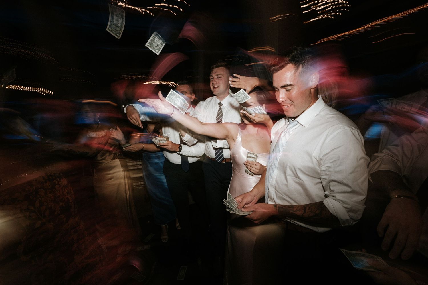 People reading by phone lights in a darkened room creating dramatic lighting effects.