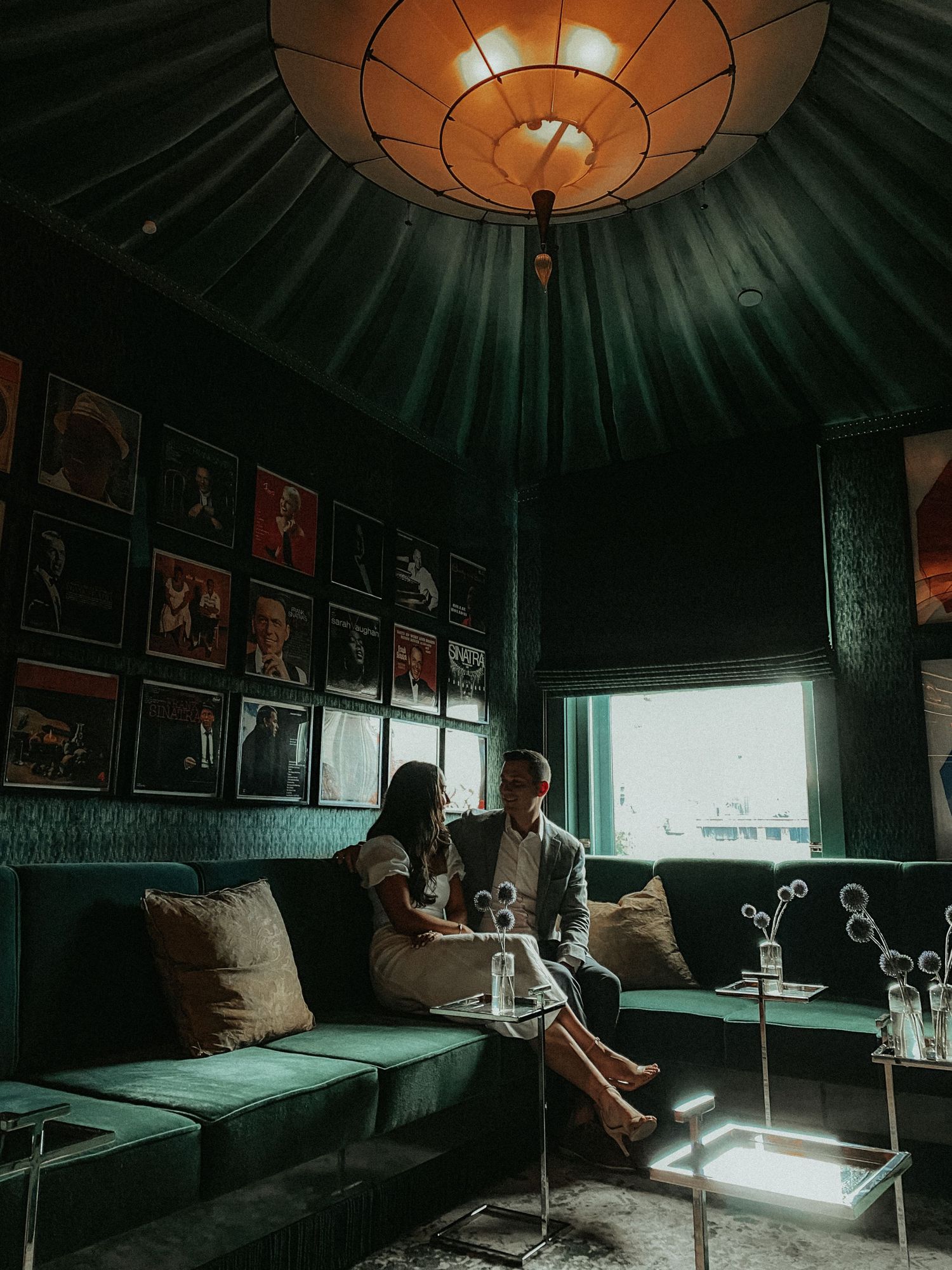 Moody interior of a circular room with vintage decor and dramatic pendant lighting creating ambient atmosphere.