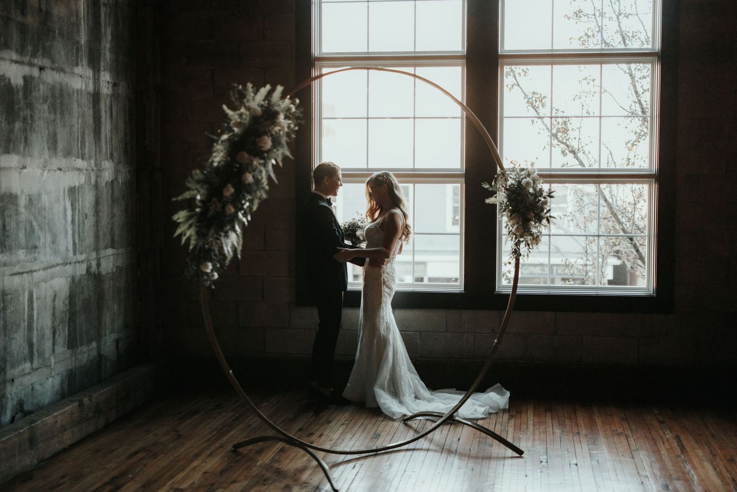 Artistic portrait series showing a figure posing with a large hoop in a rustic indoor space.