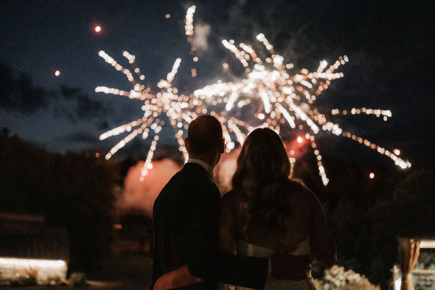Fireworks display lighting up the night sky with bursting sparkles.