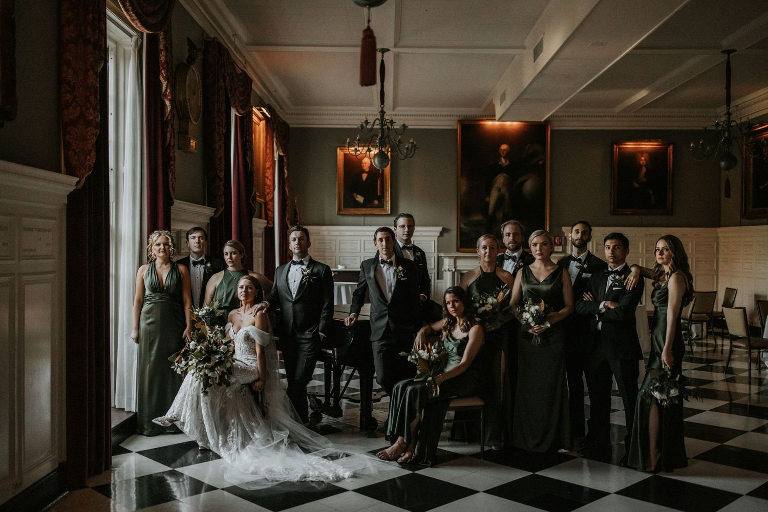 Wedding ceremony in a grand indoor venue with guests seated in rows.