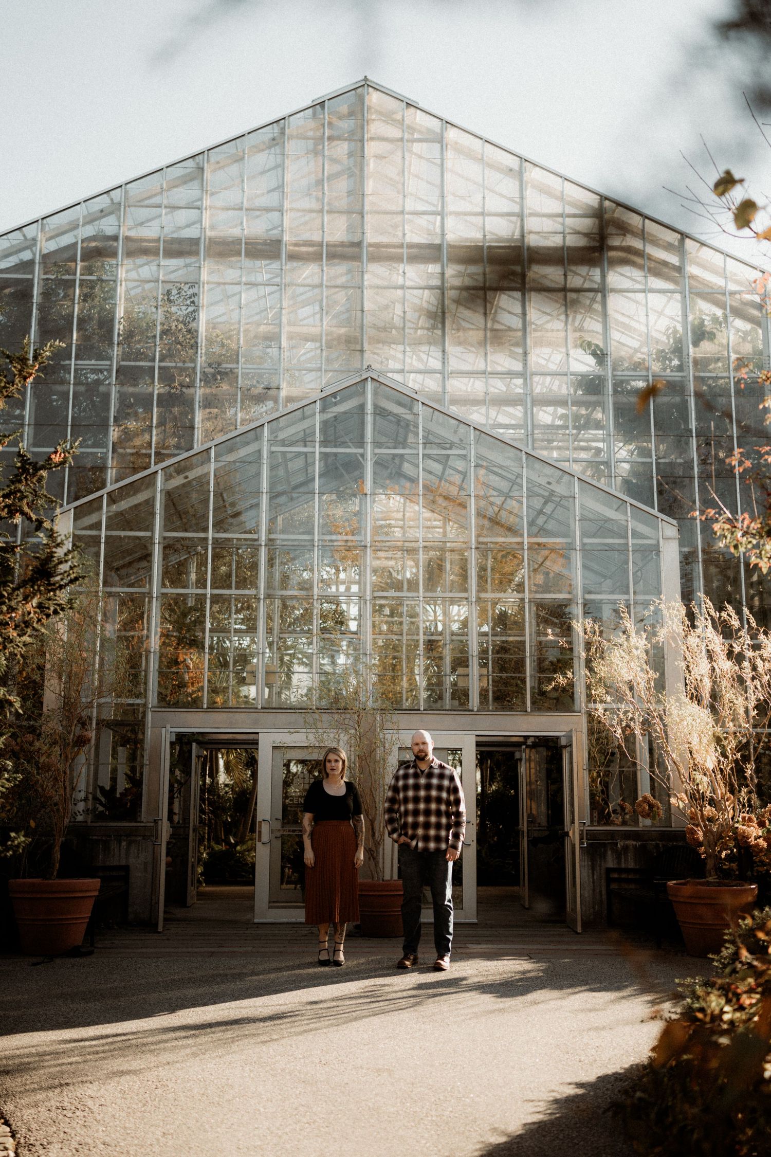 A beautiful glass greenhouse exterior shot in warm autumn light.