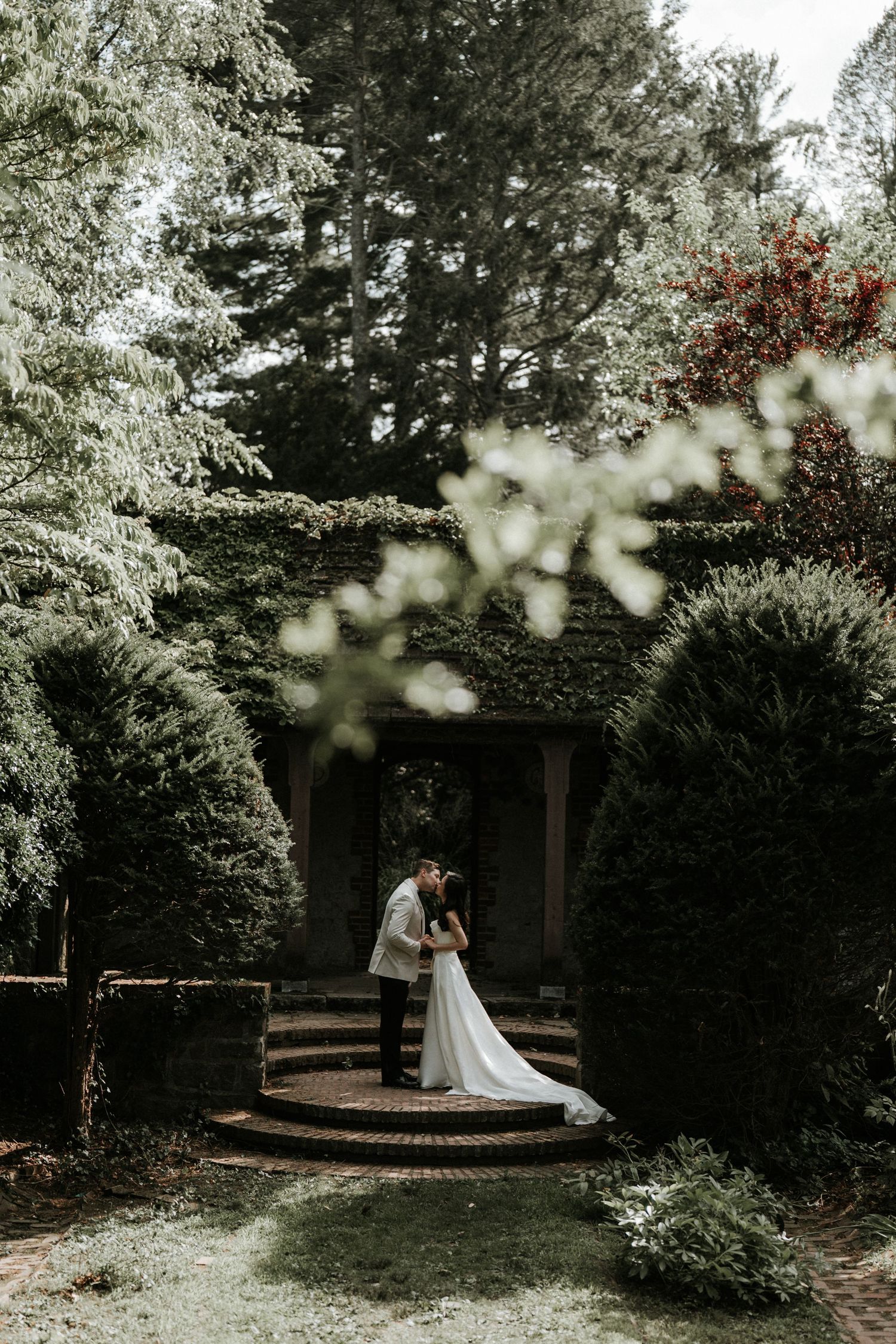 Garden wedding venue with blooming dogwood trees and natural landscaping.