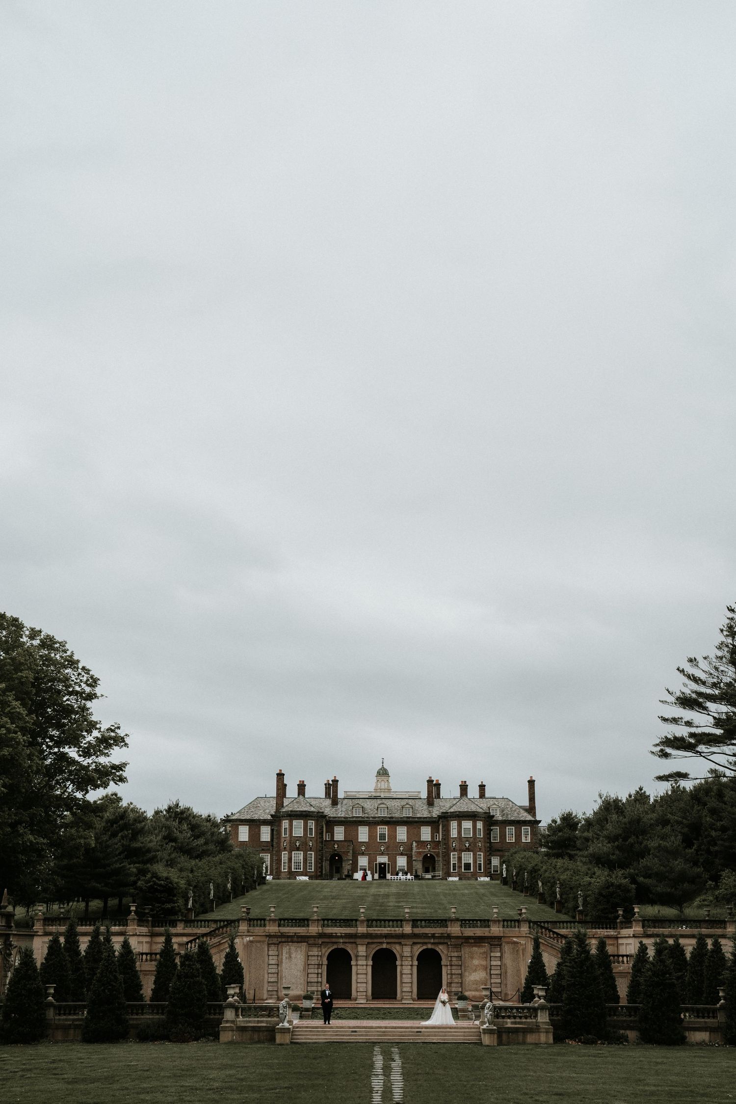 Majestic historic mansion with symmetrical architecture and formal gardens.