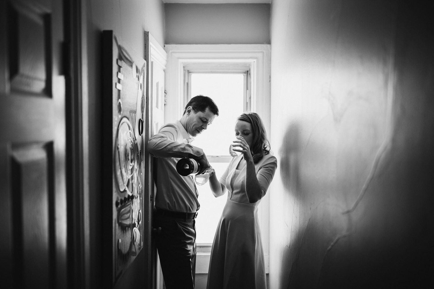 Dramatic black and white corridor shots create moody wedding day atmosphere.