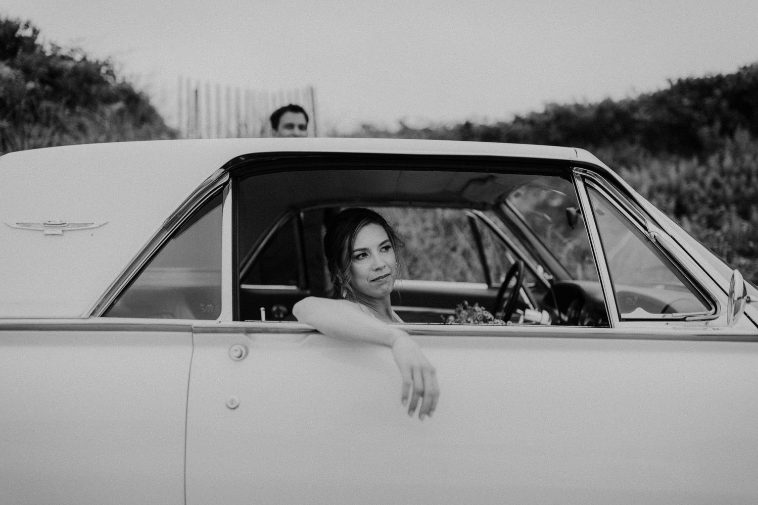 Vintage car scene captured in black and white with retro styling.