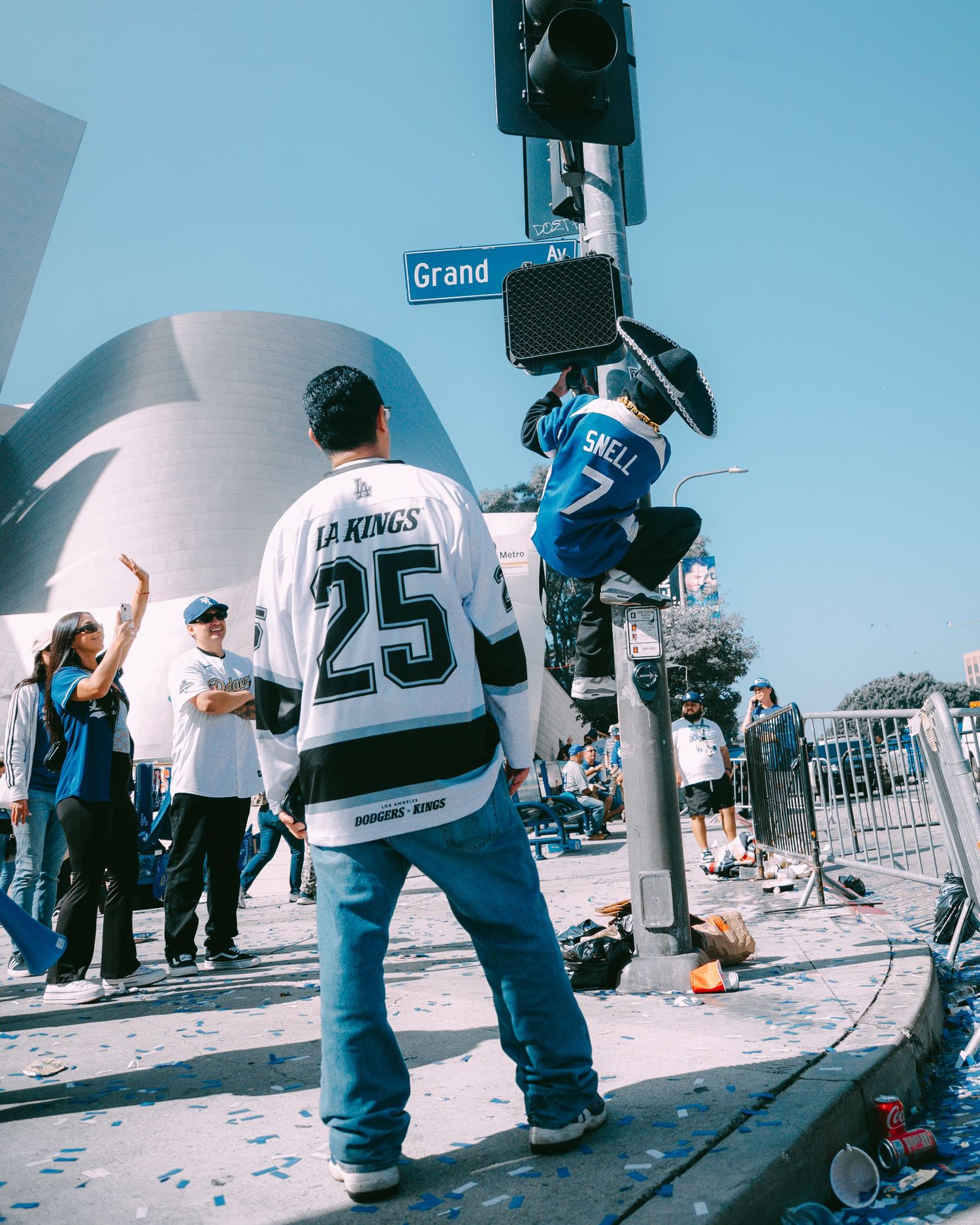 LA Kings fan in jersey #25 at a street celebration near Grand Avenue on a sunny day.