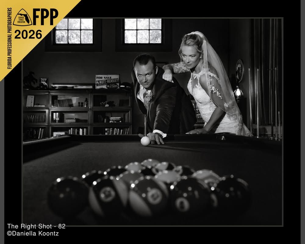 Black and white FPP 2026 award-winning wedding photo of bride and groom playing pool together.