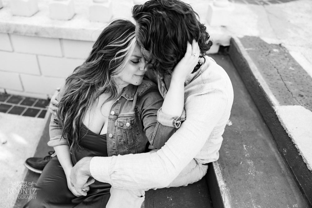 Black and white intimate portrait of couple in casual denim sharing tender moment.