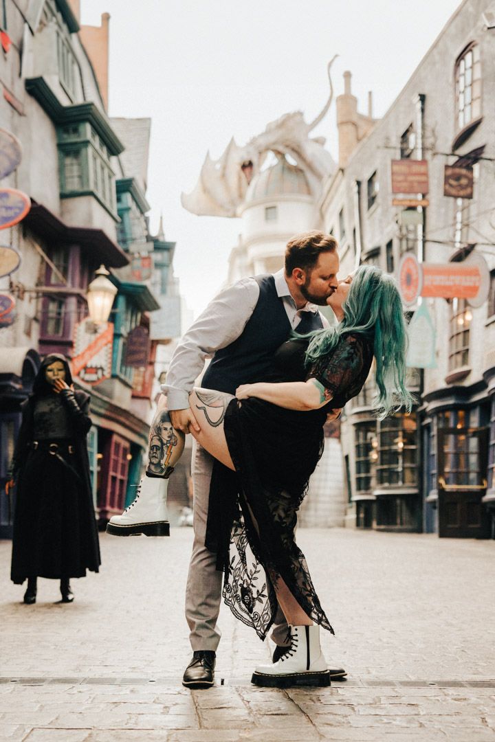 Couple sharing a dramatic dip kiss on the cobblestone streets of Diagon Alley.