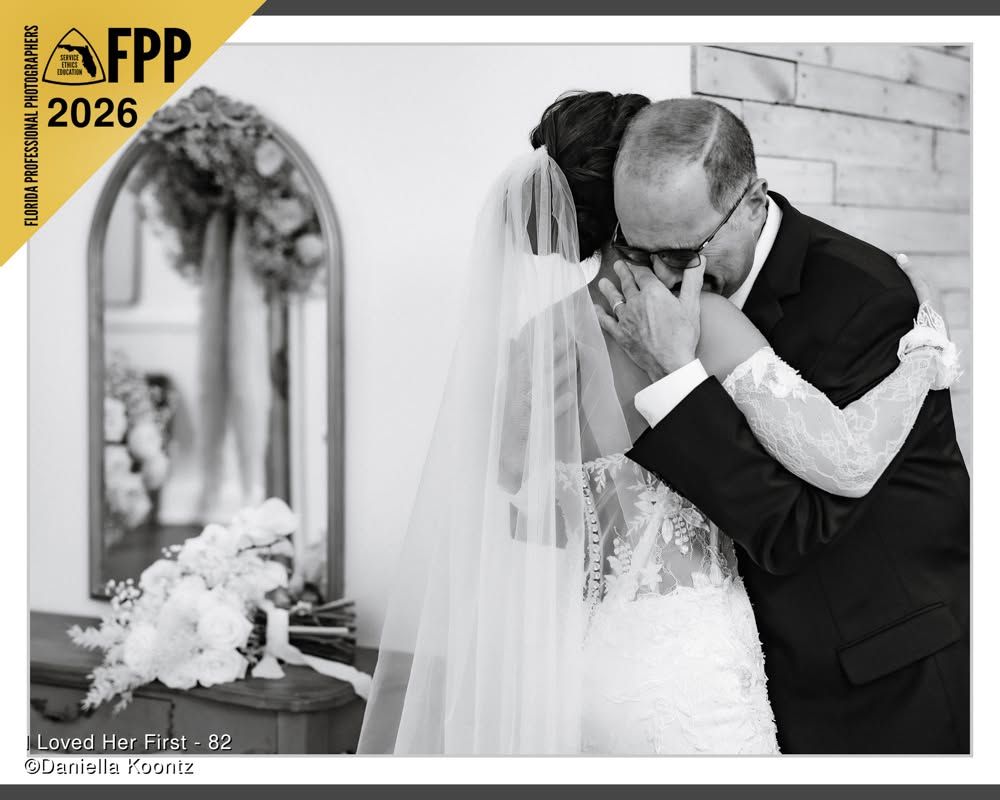 Black and white FPP 2026 award-winning wedding photo of father kissing bride on her forehead.