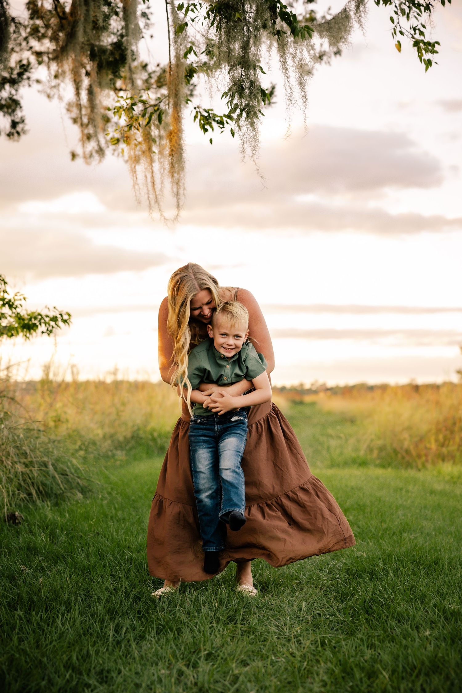 Sweet candid moment between two people playing together outdoors at sunset.