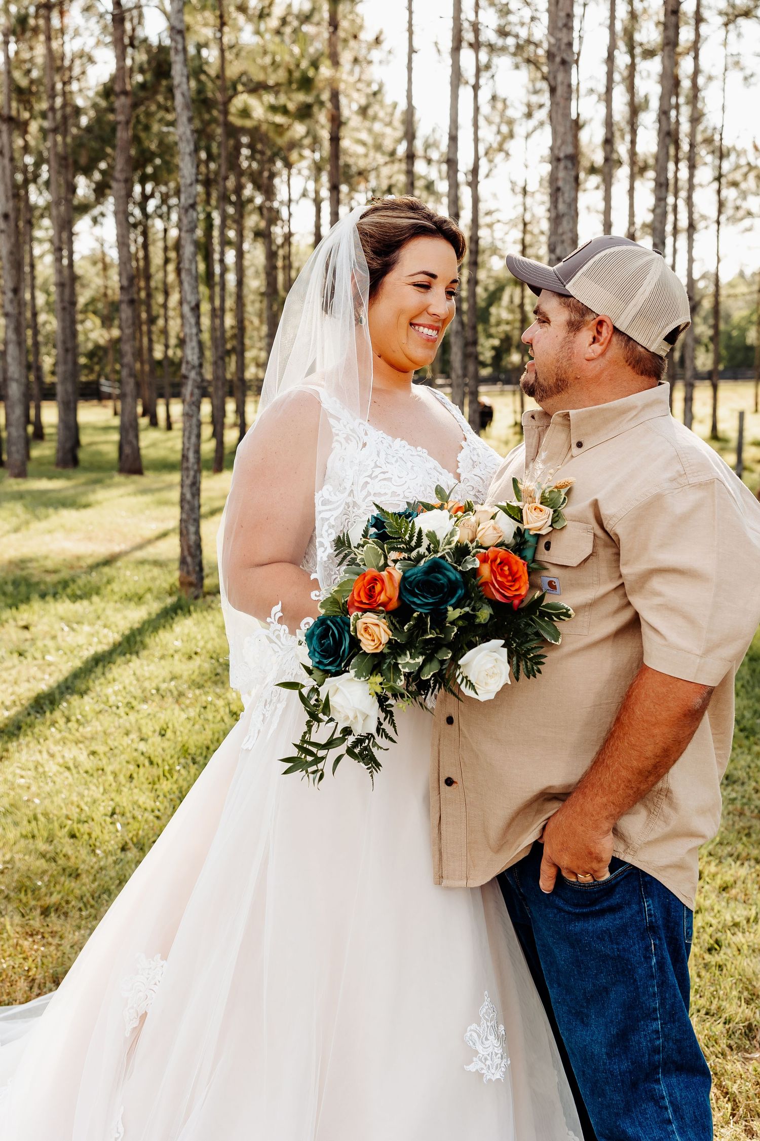 Candid wedding moment captured in sunny pine forest.