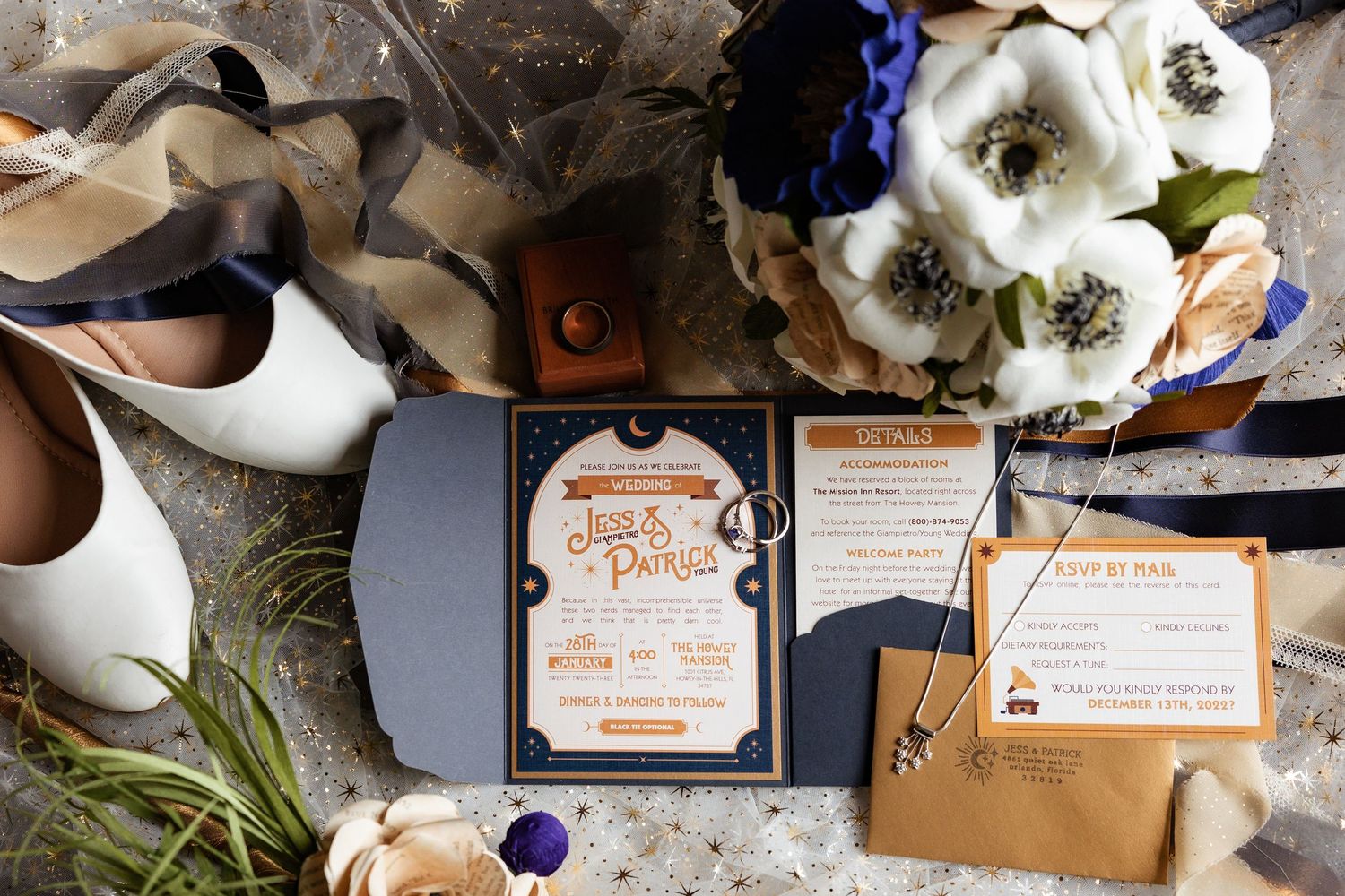Elegant wedding invitation suite for Jess and Patrick displayed with floral bouquet and bridal shoes.